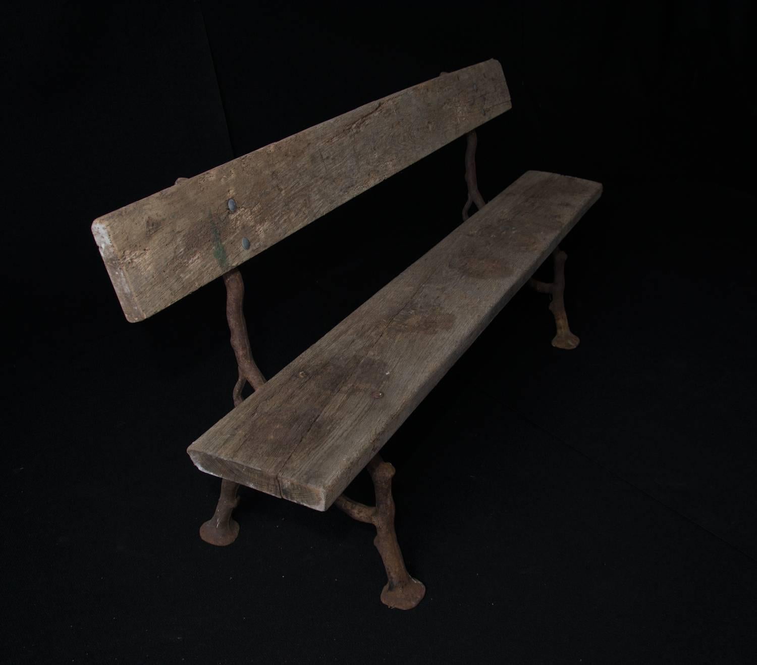 Unique late 19th century French garden bench with unusual faux bois cast-iron legs and a fabulous aged patina.

