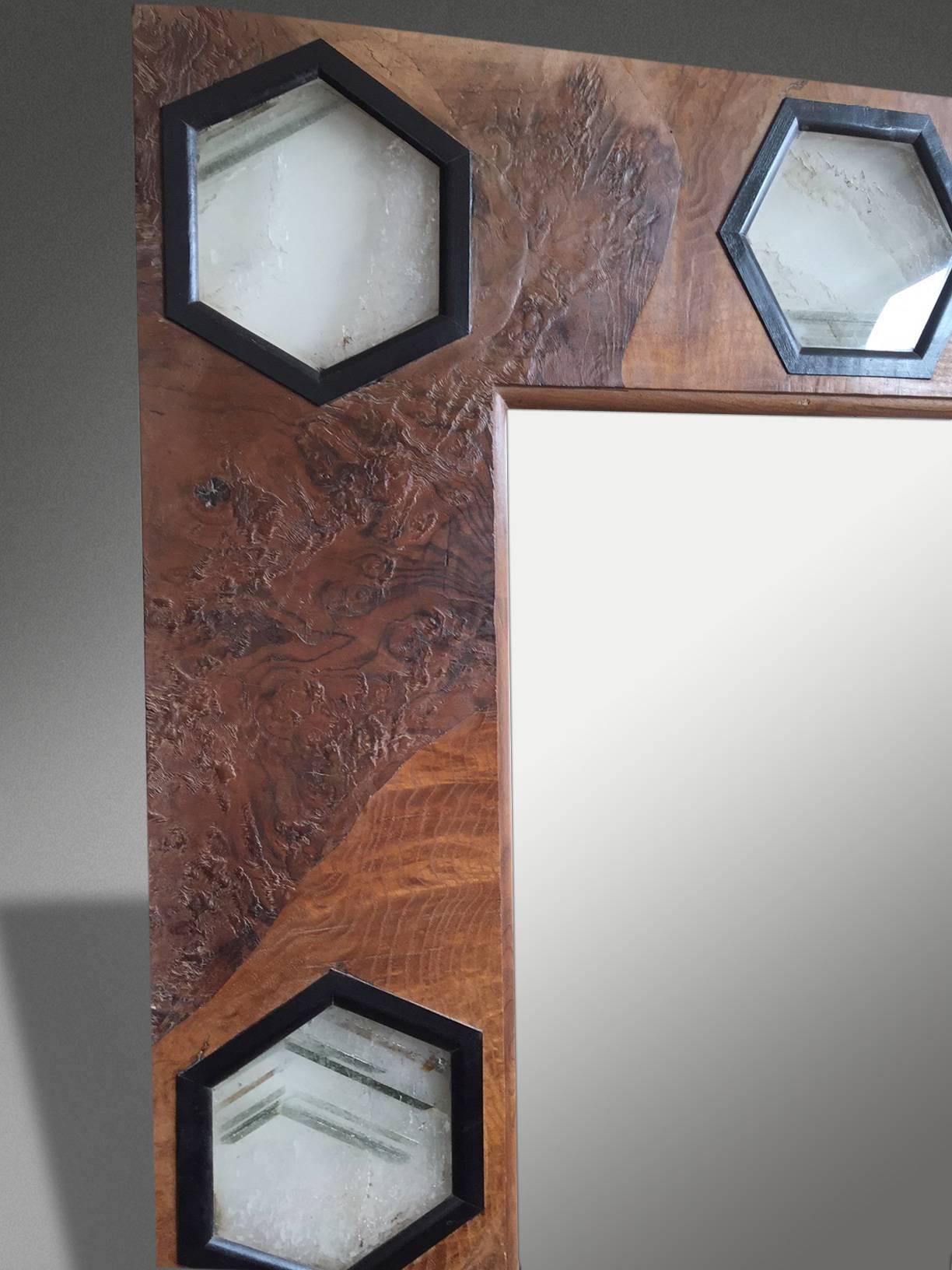A 1930s style mirror with rare veneers and solid quartz hexagonal plaques in ebonized frames.

The quartz is backlit with varied colored LED lighting.