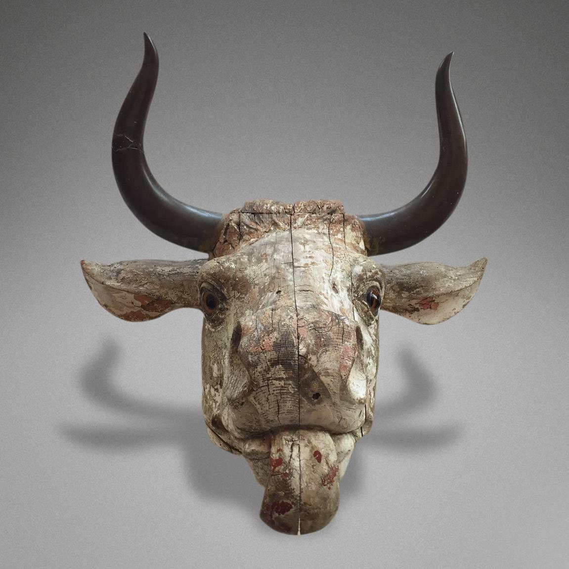 An unusual finely carved and polychromed head of a bull with bronze horns, low countries or France, 19th century.