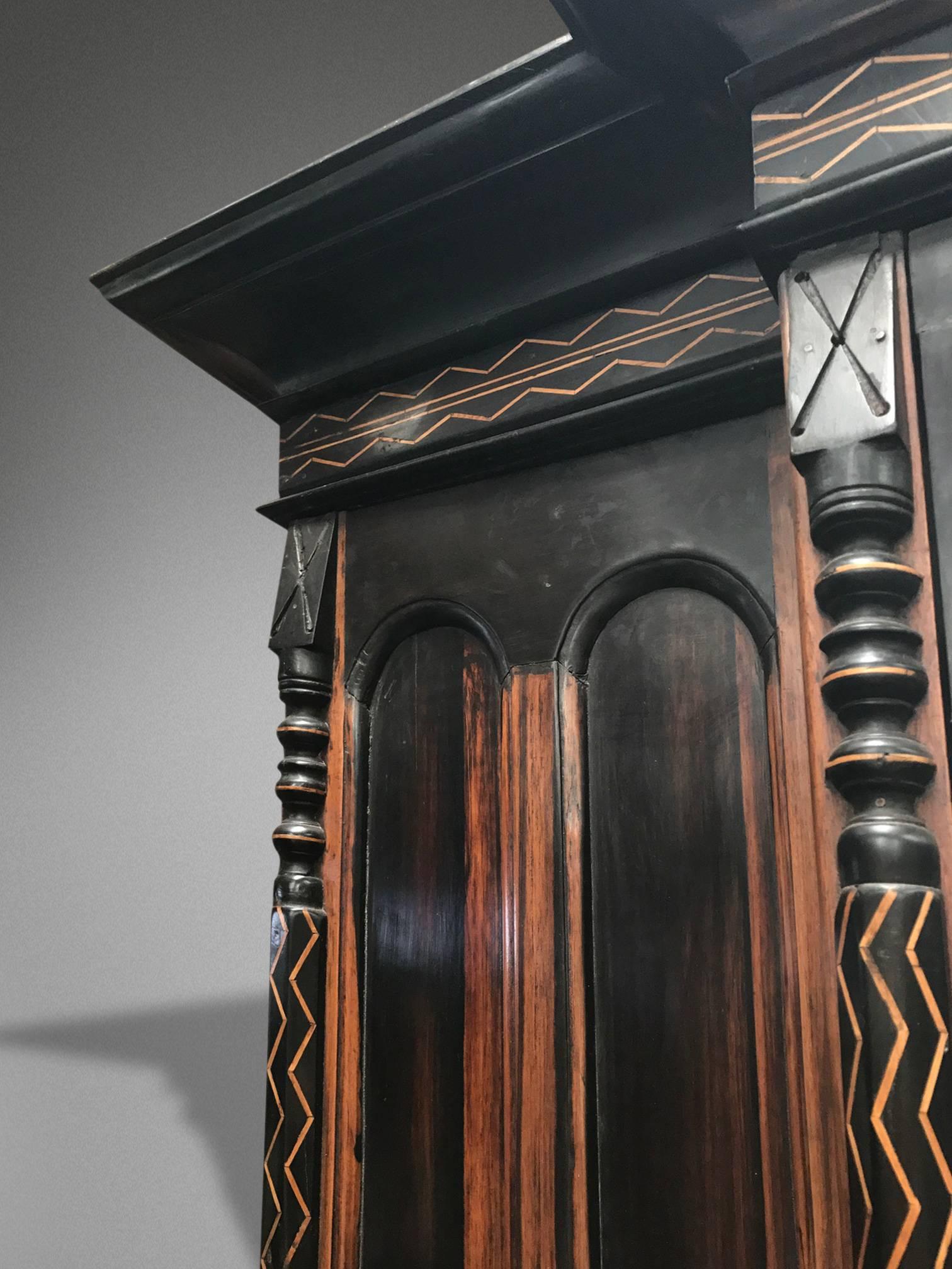 Variegated solid ebony cabinet, five doors and three draws. Including a mirror in the central door,

circa early 19th century.
