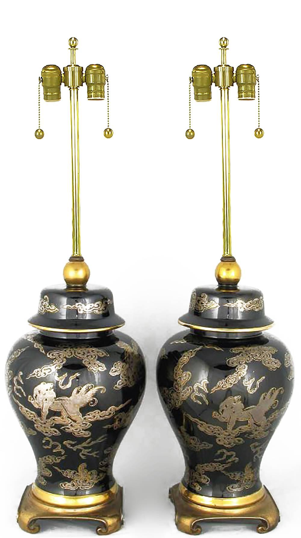 Elegant black and gilt Asian ginger jar form table lamps with solid brass turned feet bases. Sold sans shades.