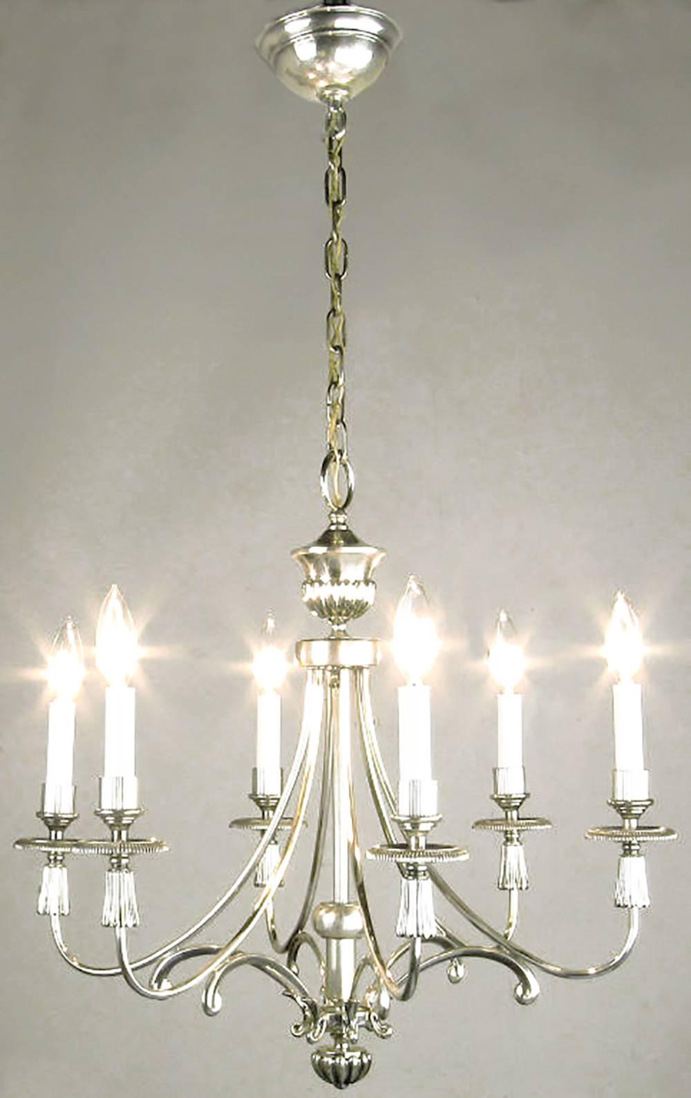 Silver-plated six-arm Regency chandelier from Lightolier. Certain characteristics are similar to the design elements of Parzinger's work for Lightolier. Specifically, the silver table lamps and table top torcheres Lightolier marketed in the 1950s.