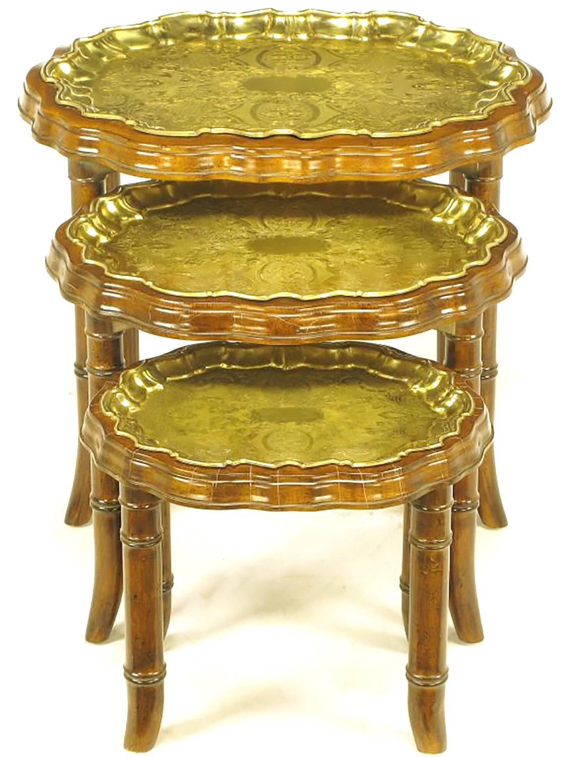 Set of three carved walnut wood, bamboo-form stacking/nesting tables with removable molded and etched brass trays that mirror the scalloped edge tops. Substantial in weight and very well manufactured.

Individual dimensions:

Small 13.5