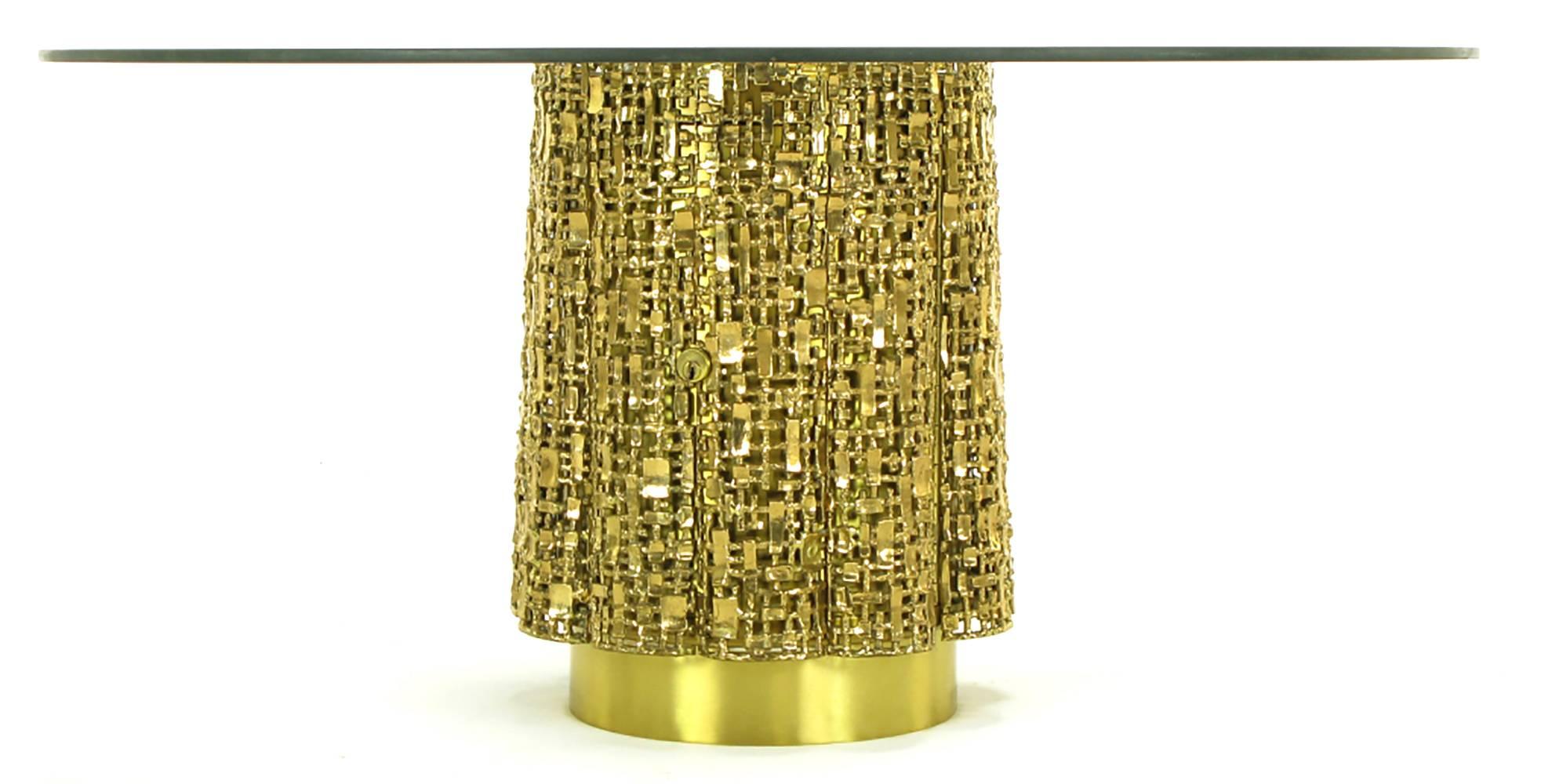 Elegant, one of a kind custom pierced brass pedestal base coffee table in the manner of Silas Seandel. Cast brass quarter round panels encircle the brass clad center wood cylinder. Concealed keyed and hinged door open to reveal simulated calf