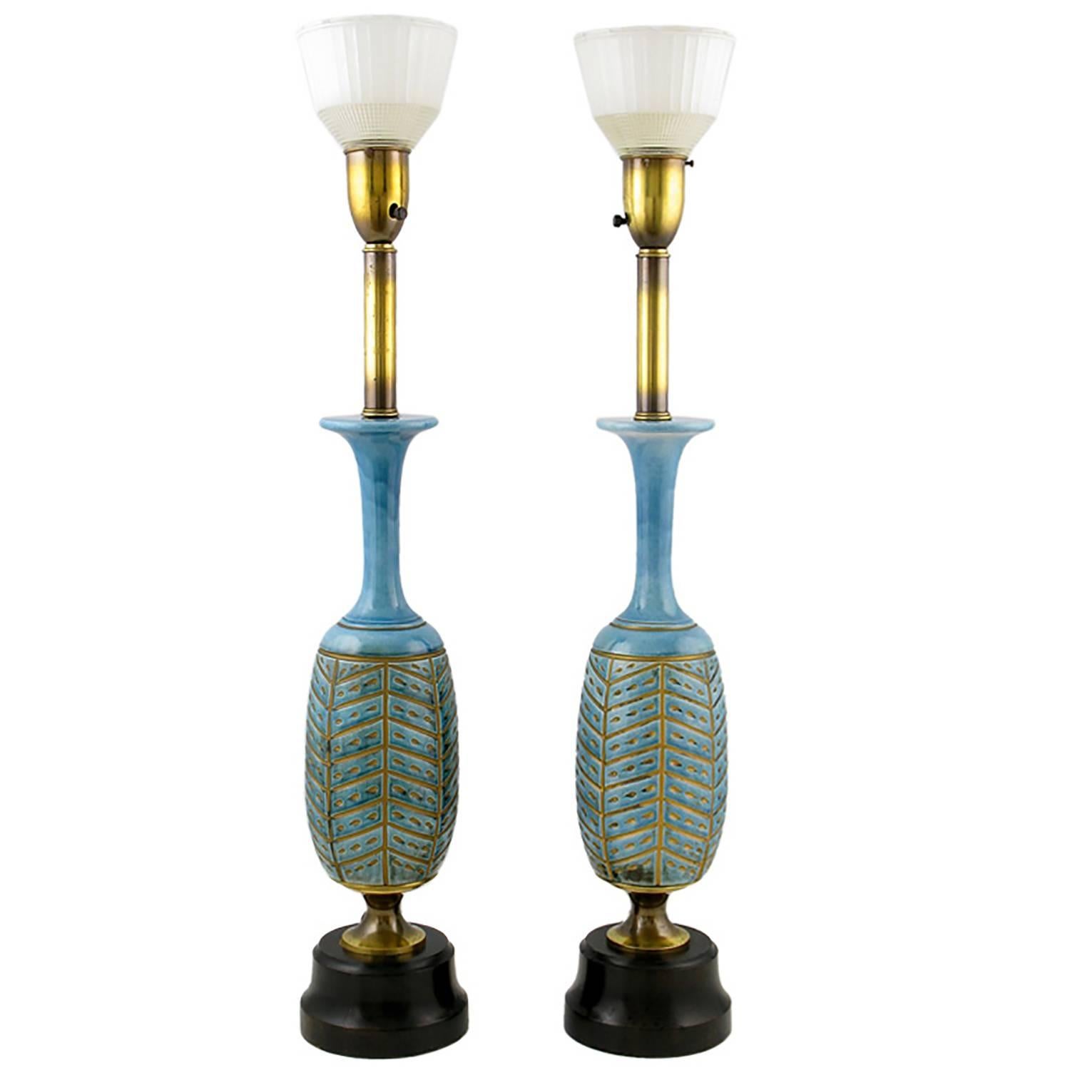 Statuesque pair of beautifully glazed baluster-form ceramic table lamps with impressed and gilt herringbone design. Ebonized wood base and original clear and milk glass diffusers. Attributed to Rembrandt Lamps, due to the style of diffuser and brass