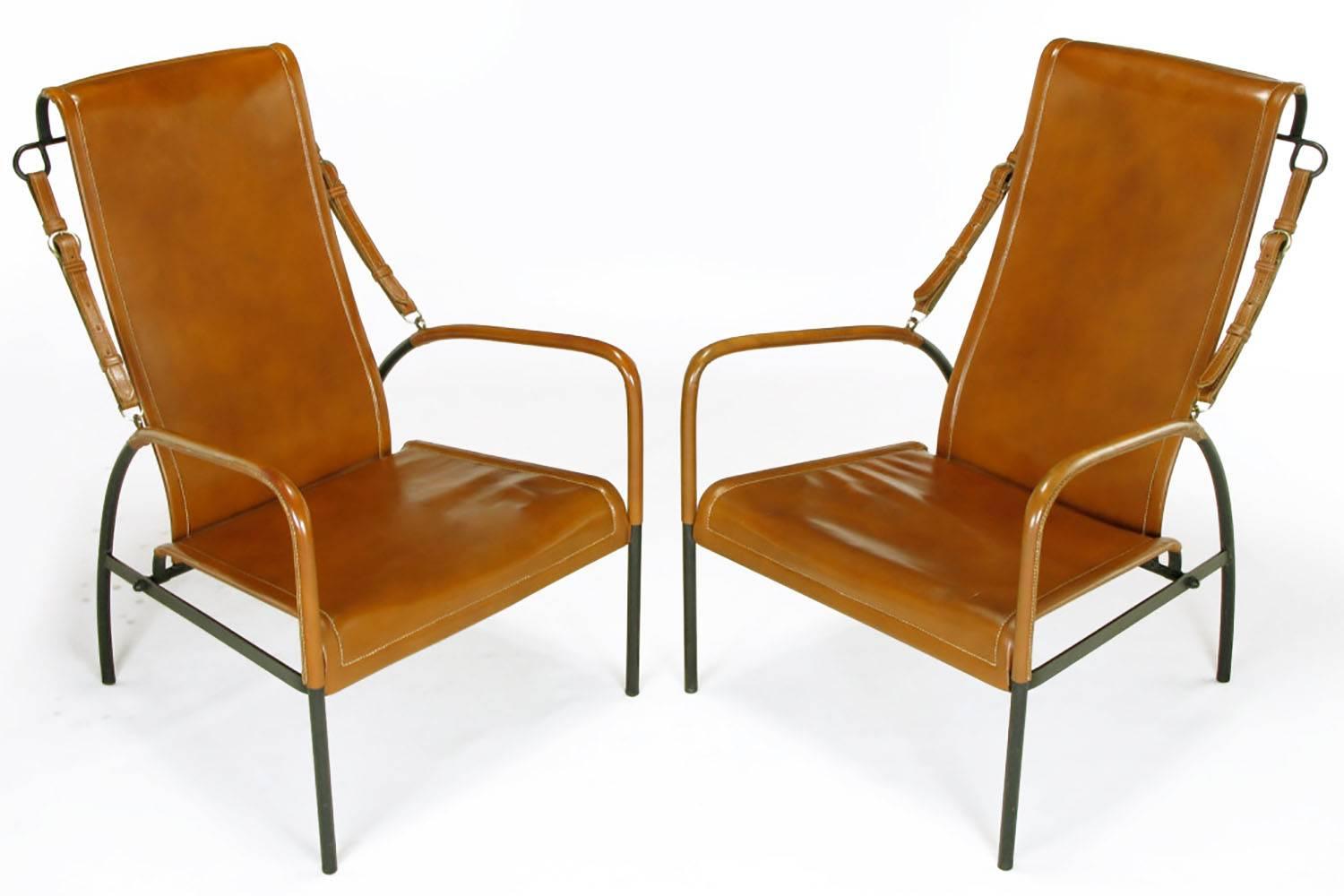 Pair of custom leather lounge chairs with wrought iron frames and saddle leather seats and backs in the style of Jacques Adnet. Fabricated in Chicago by Paul's Custom Saddlery and Harness for the owners of an Illinois equestrian estate. Saddle
