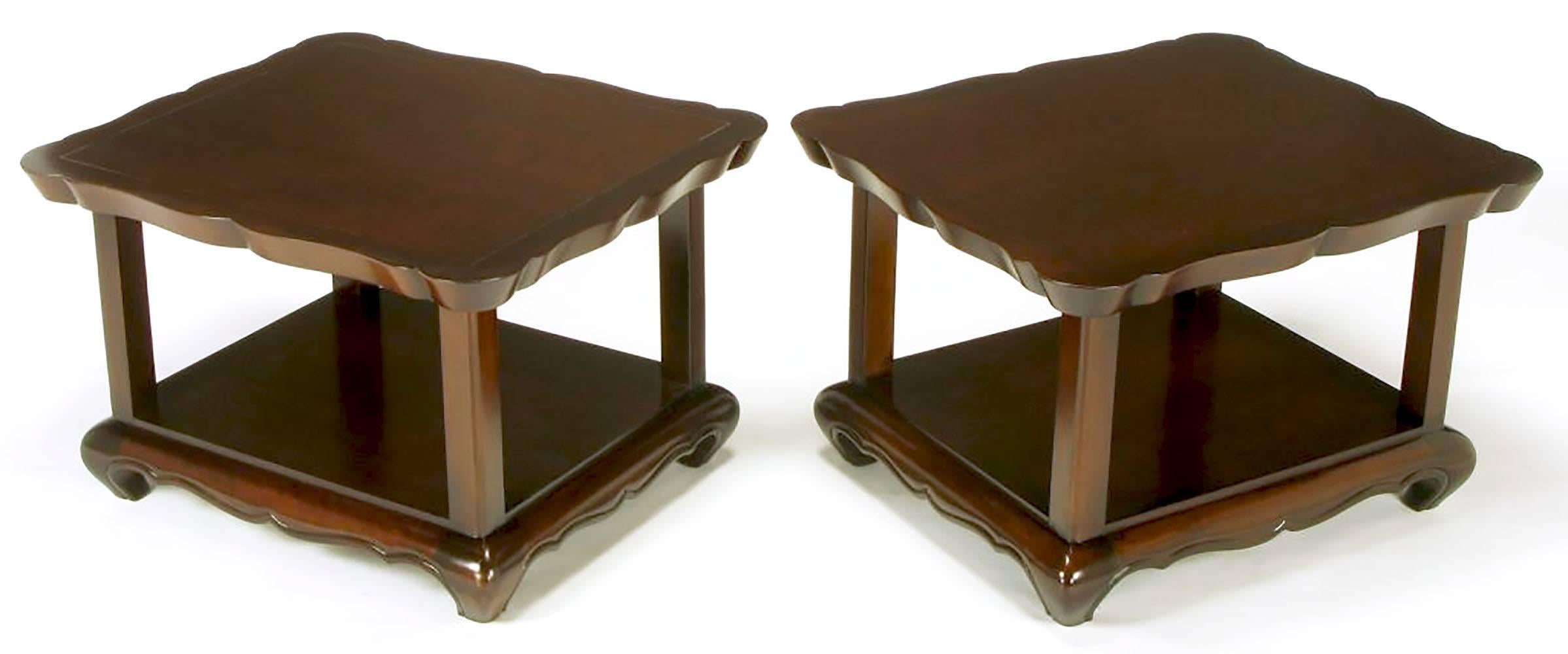 Asian inspired two-tiered side tables with scalloped edge, incised border top. Squared column supports and raised bottom surface. Scalloped and beaded apron with exaggerated returned legs. Completely restored, exceptional build quality, walnut
