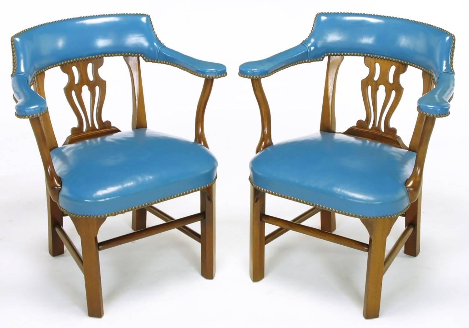 Pair of Chippendale influenced armchairs from Barnard & Simonds, Rochester, NY. Cadet blue leather wrapped arms, back as well as seat with brass nailhead details. Mahogany frames have canted front legs, Chippendale style open back and four part