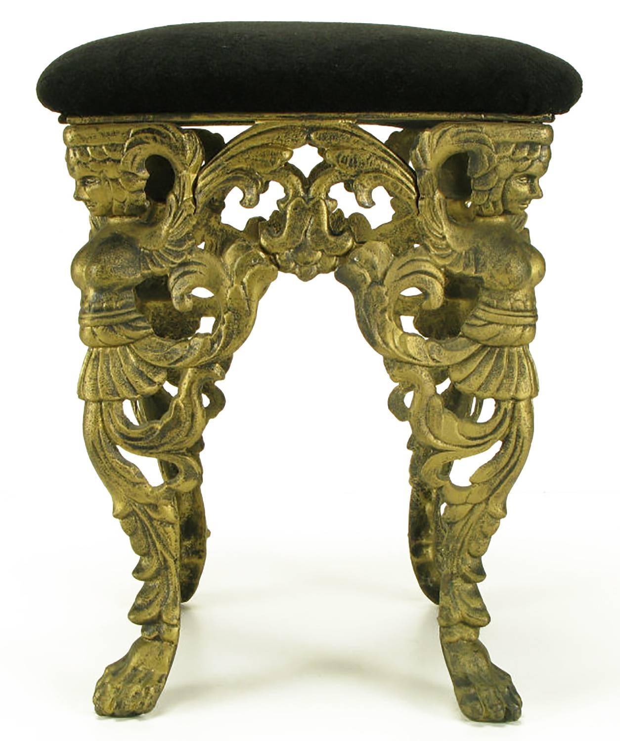 Cast iron Empire style bench with paw feet, draped swag and winged maidens, patinated bronze lacquer finish. Black textured velvet seat covering. Would also make an uncommon vanity seat.