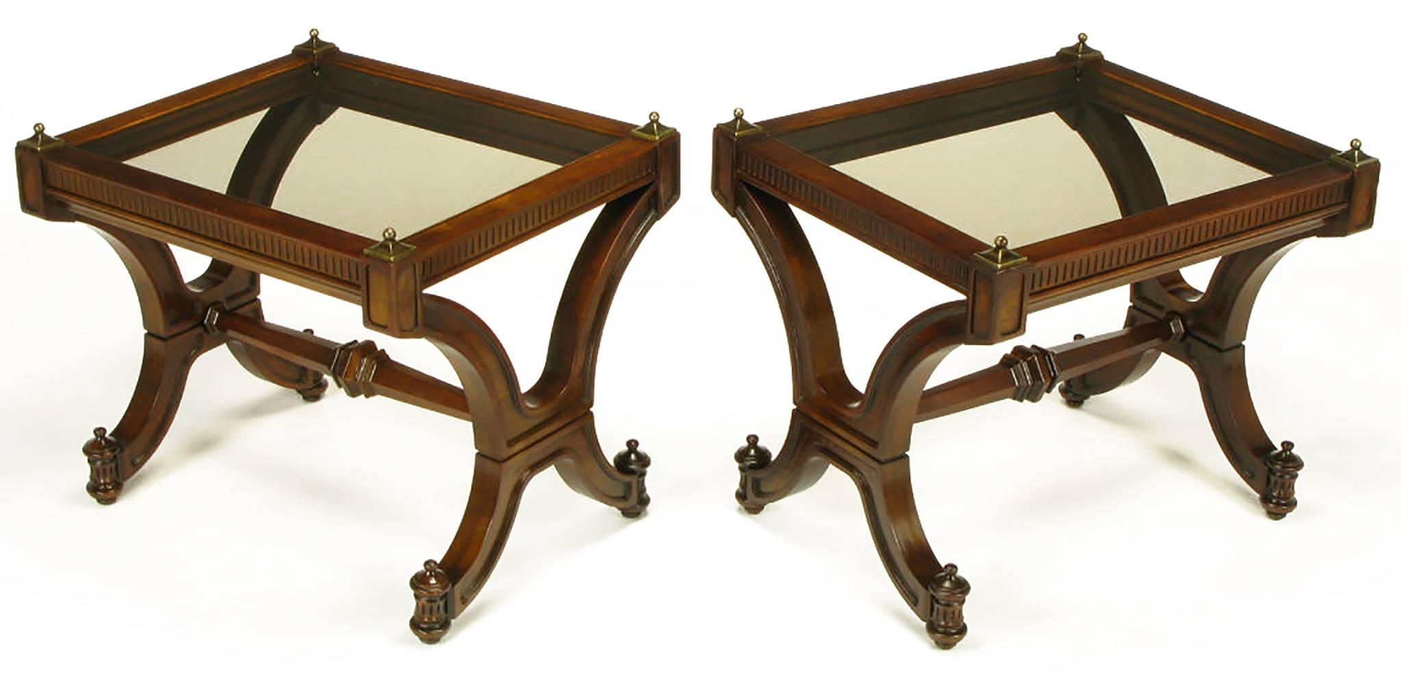 Pair of Empire revival end tables in mahogany wood with curved X-form legs, and substantial hexagonal carved center stretcher. Recessed carved panels on the interior and exterior of the legs. Finial topped feet are fluted half round columns. Fluted