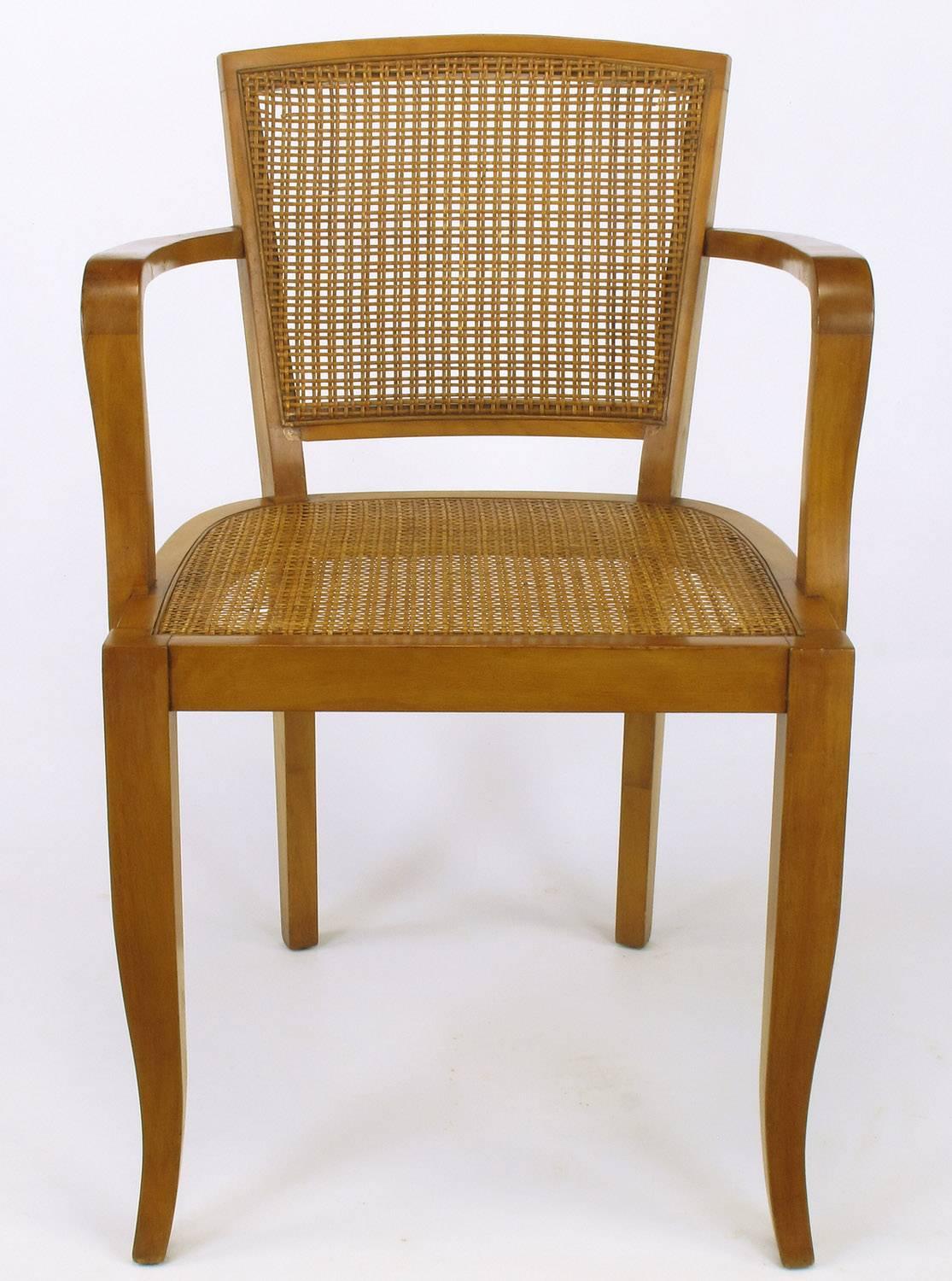 Expertly designed and constructed cherrywood armchairs with tight Danish weave cane seats and backs. Saber front legs and slightly raked back legs. Sturdy and strong chairs with multiple applications.