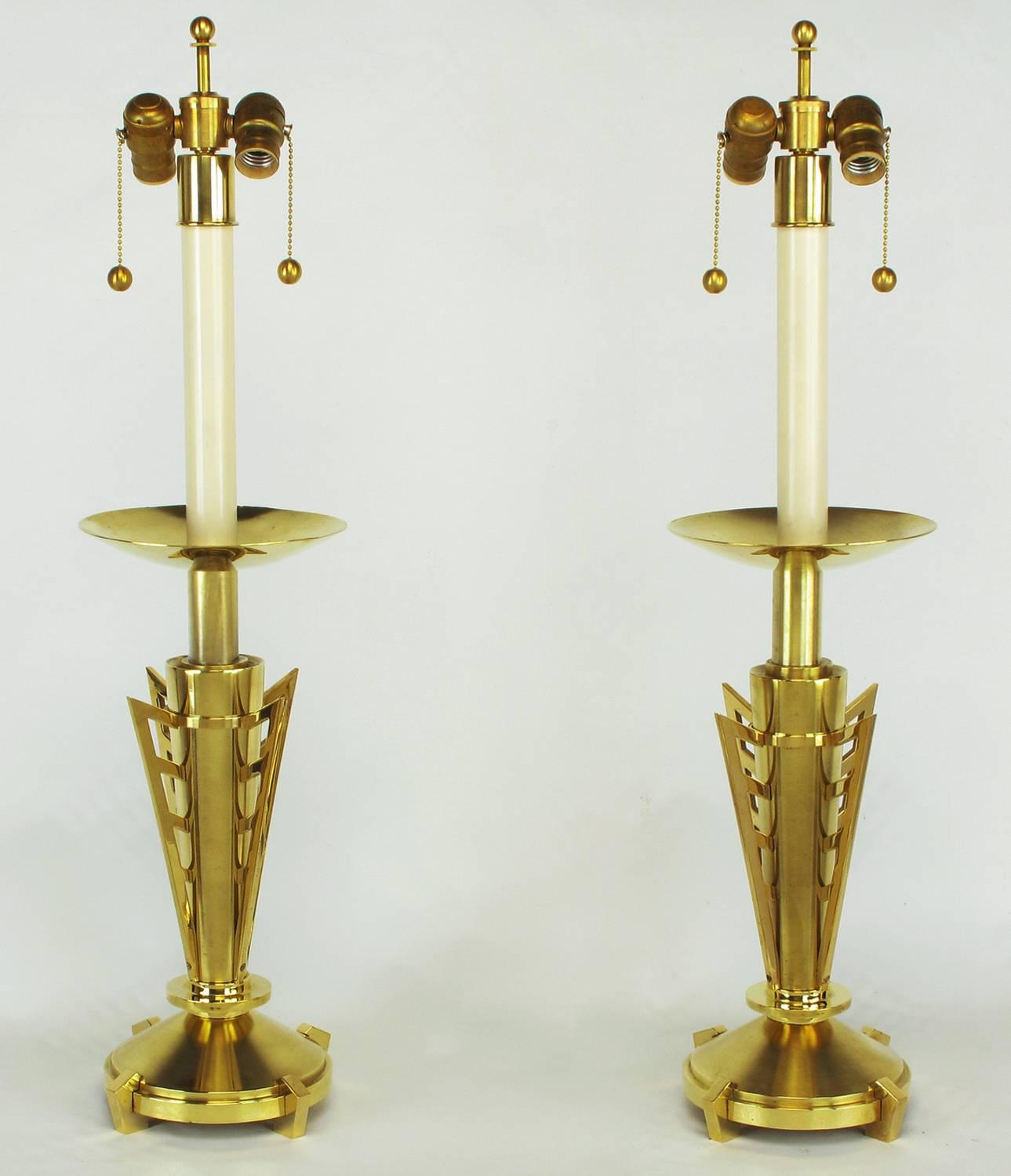 Pair of custom table lamps constructed of finely machined solid brass. Canted and polished feet on round plinth bases. Bodies are conical brushed brass with four polished brass machine age wings. Large bobeche polished on one side and brushed on