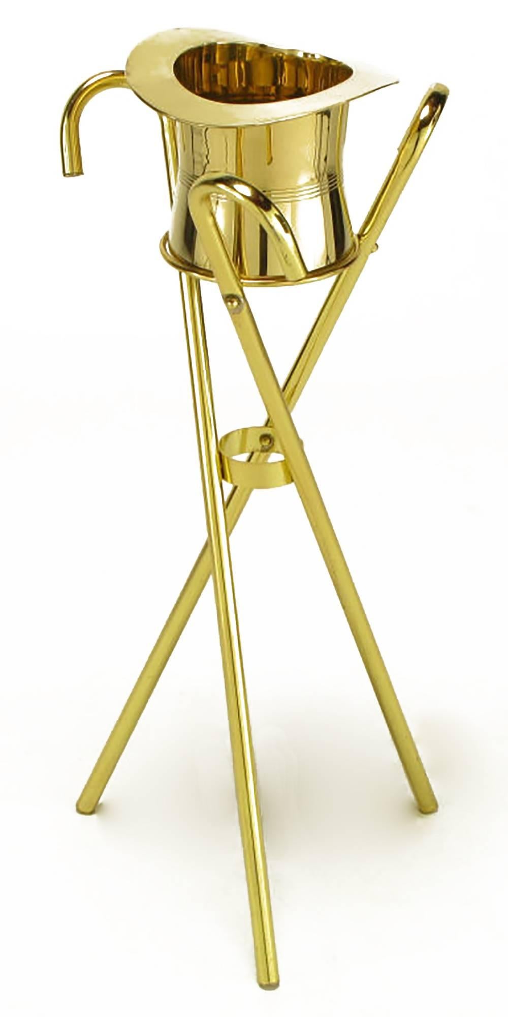 Unique and inspired champagne cooler or ice bucket on three canes in tripodal form stand. Solid brass top hat and brass-plated canes.