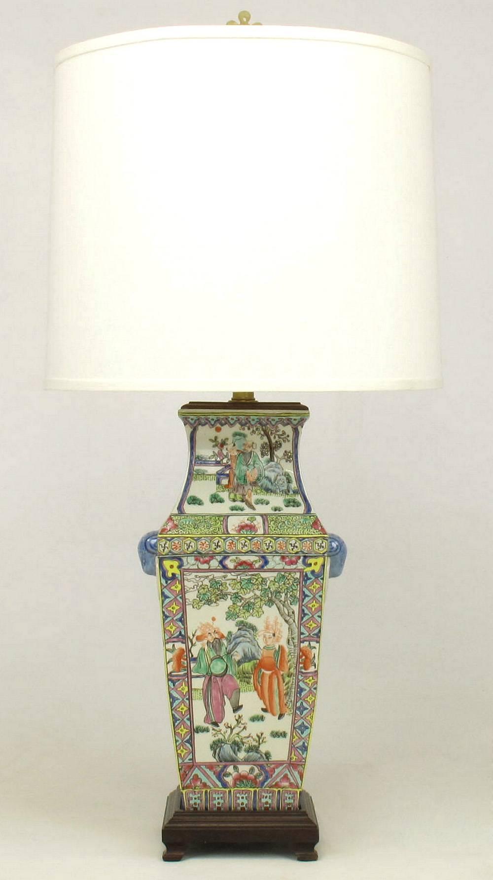 Pair of Chinese vases turned into unique table lamps from Windemere Lamps for Lotus Arts. Hand-painted porcelain vases with stylized ram head side handles. Mahogany cap and footed base. 

Lotus Arts was founded in 1980 as a source for the rare and