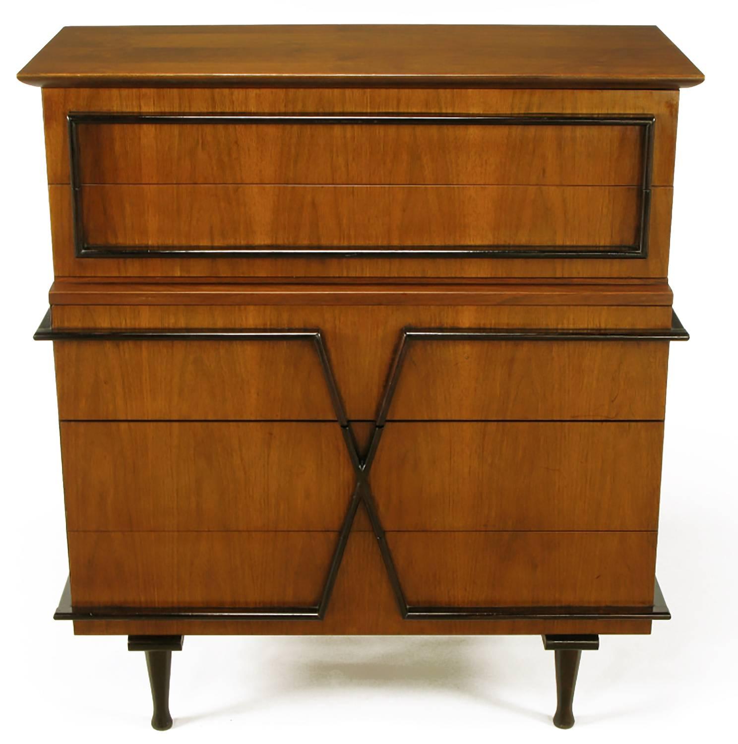 Walnut tall chest by American of Martinsville. Five-drawer front with darker lacquered rectangular and X-shaped relief appointments. The relief bullnose detailing also functions as the drawer pulls. Top two drawers slightly stepped back.