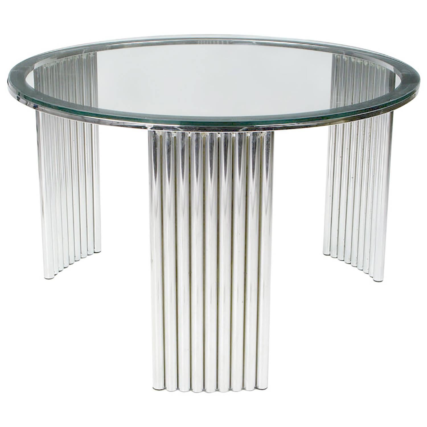 27 welded and chromed tubes form the three radius supports for this deco-Futurist coffee table, which would also work well as a large end table. The 3/8