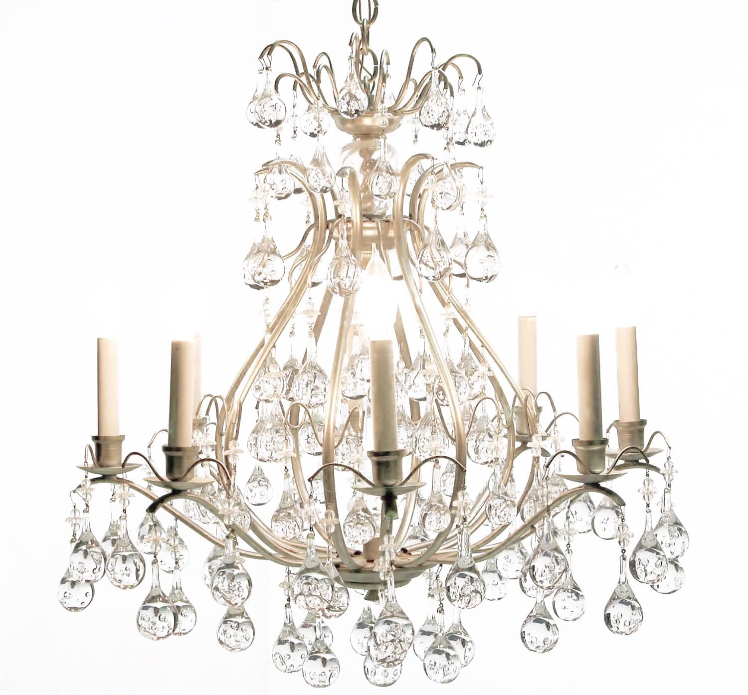 Striking eight-arm chandelier in brushed nickel, with a gourd form open center and rain drop bubble crystals adding a modern touch. Multiple tiers of crystals give the appearance of water gently dripping from the brushed nickel frame. Comes with