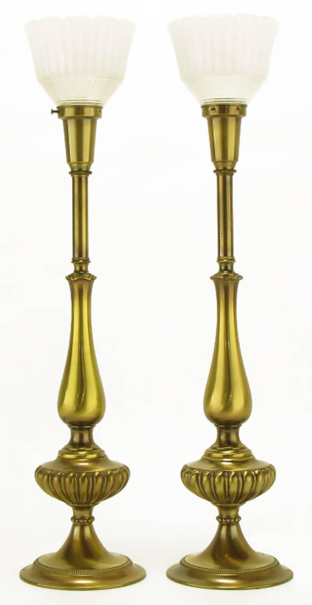 Elegant pair of solid brass Regency style table lamps from Rembrandt Lamp Company. Flanged base with egg and dart body that resembles the oil basins of pre-electric lamps. Antique lacquer finish with original glass diffuser. Sold sans shades.