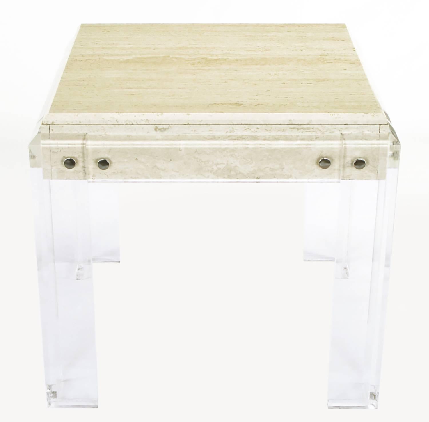 Postmodern game table with Lucite legs and apron. Travertine beveled edge top with travertine panels behind the Lucite apron. Large chrome finishes cylindrical cap nuts.