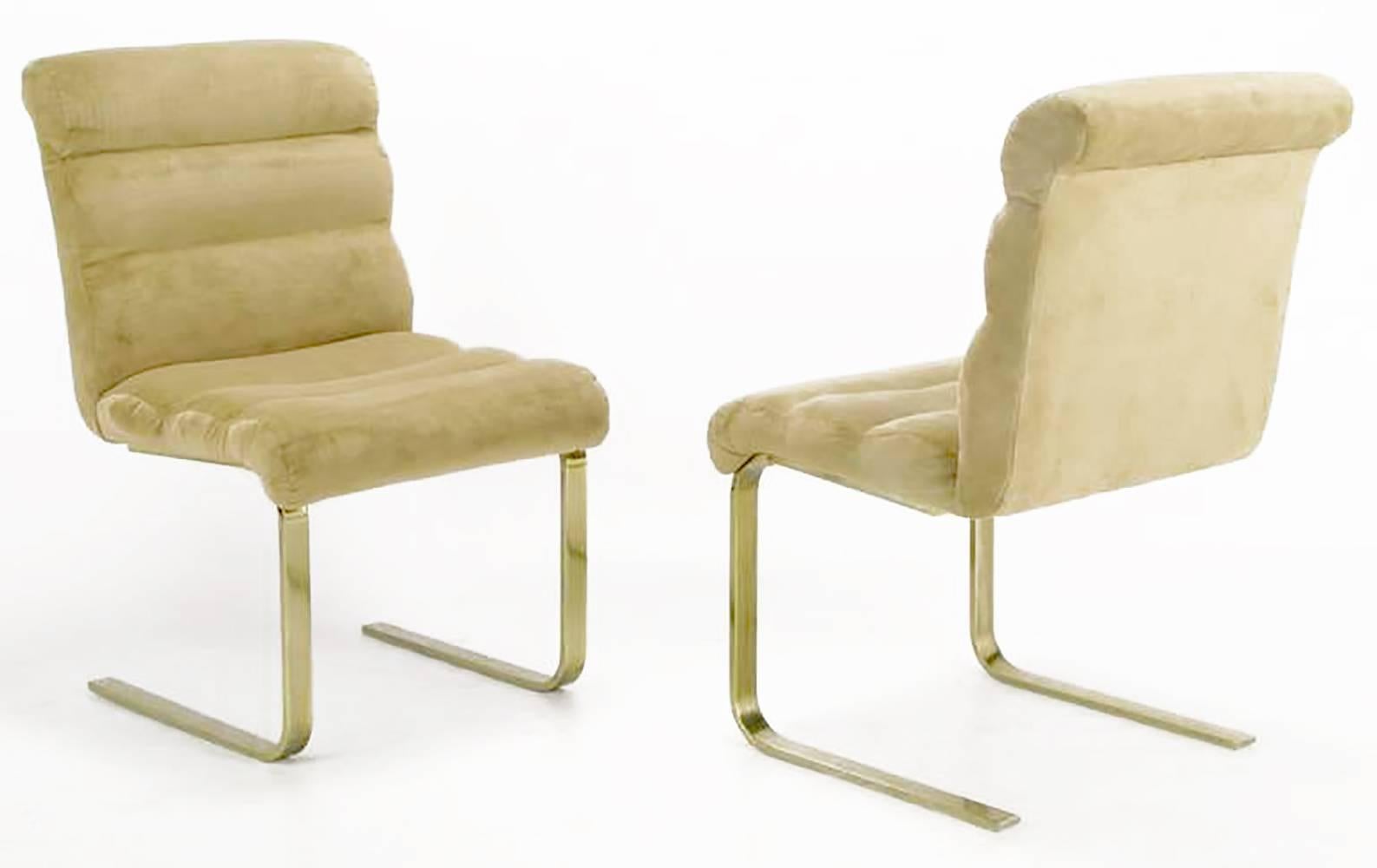 Set of four cantilevered Lugano dining chairs, by Mariani for Pace Collection. Legs are lacquered and toned brass. Seats and backs are one piece bentwood covered in a rolled tan ultra suede. 

Brass toned legs can be stripped and polished to