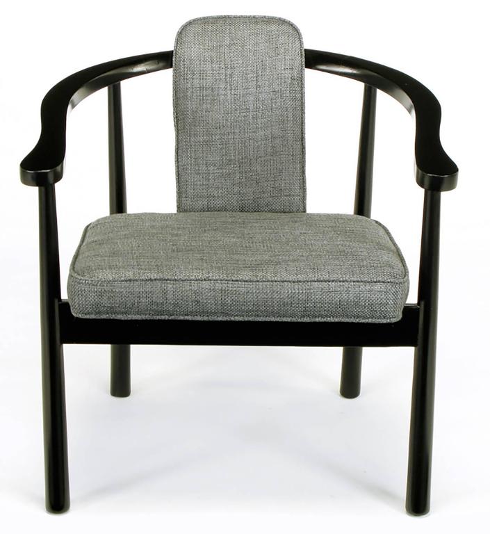 Set of six Asian influenced dining armchairs clad in new heathered slate grey linen upholstery. Narrow curved back with a forward slant seat, ebonized frames with yoke arms and reverse tapered legs. Great build quality on par with Dunbar or Baker.