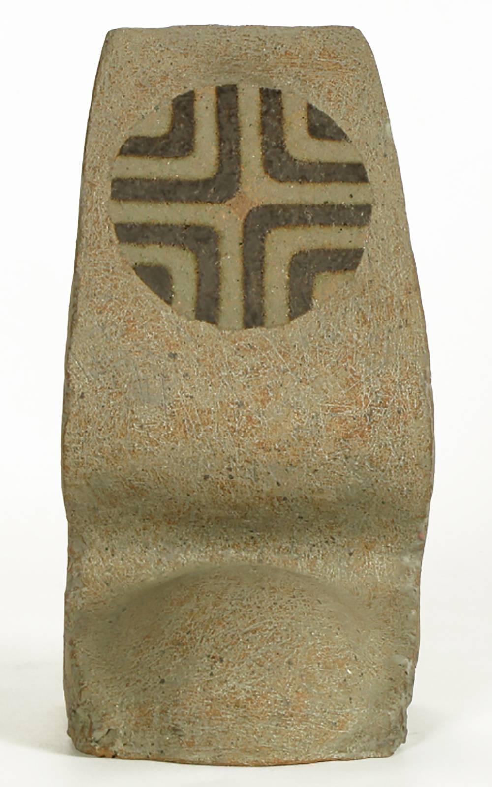 Heathered earthen glazed terra cotta sculpture by Tomiya Matsuda (1939-2011). A sinuous abstract shape with unfinished sides and half round base. Geometric top circular detail. Tomiya Matsuda (1939-2011) studied at the Kyoto University during the