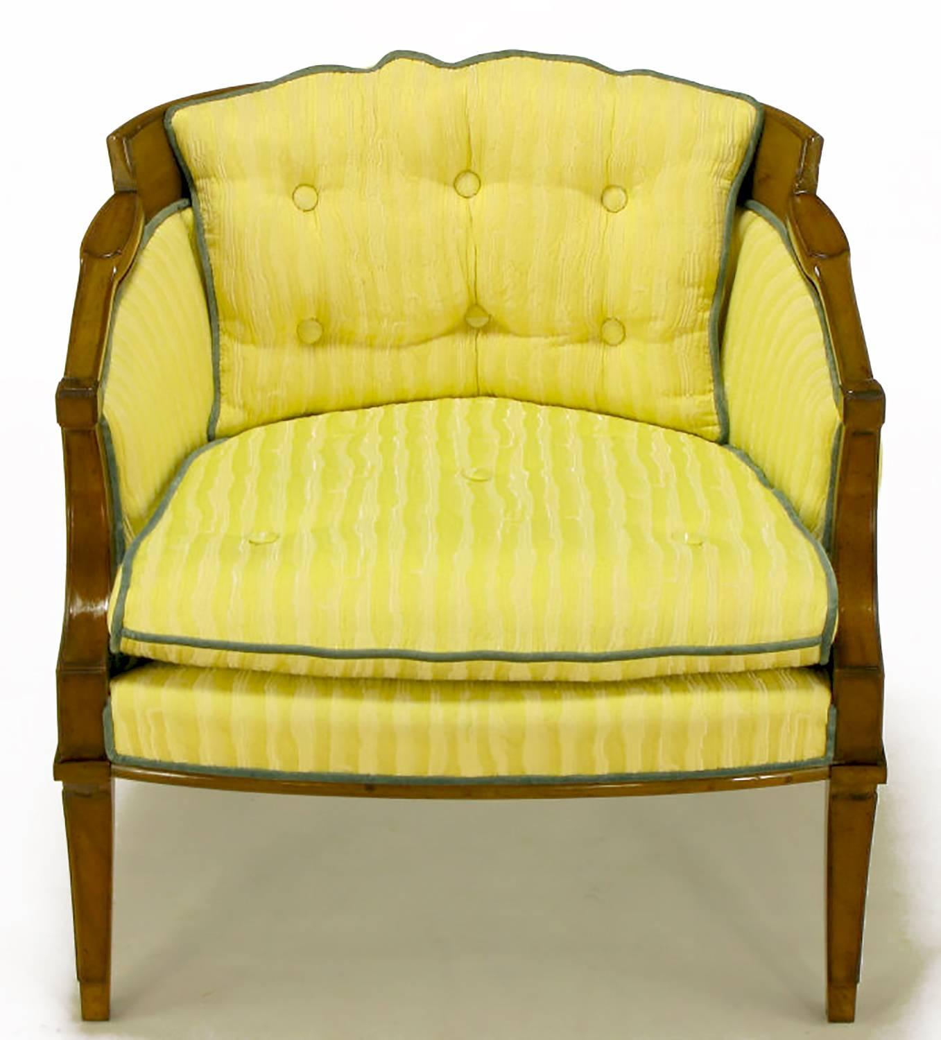 Pair of Oxford Ltd lounge chairs with carved walnut Regency frame. Saber front and back legs with nicely detailed arms and back. Fixed button tufted back cushion, loose seat cushion in a saffron striped linen and silk blend upholstery, with