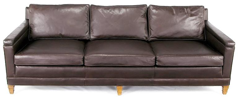 Heritage Furniture chocolate brown leather upholstered three seat Regency style sofa. Loose seat and black cushions with bleached and patinated mahogany legs. Originally sold through Colby's, Chicago finest furniture dealer for decades until it