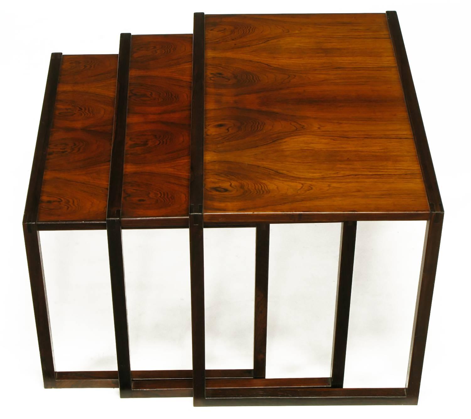 Spare in line, these three tables are topped by matching and highly figured rosewood veneers. Would work well as an end or side table. Rectilinear frames of rosewood crafted to nestle smaller-into-larger. Designed by Kai Kristiansen and manufactured