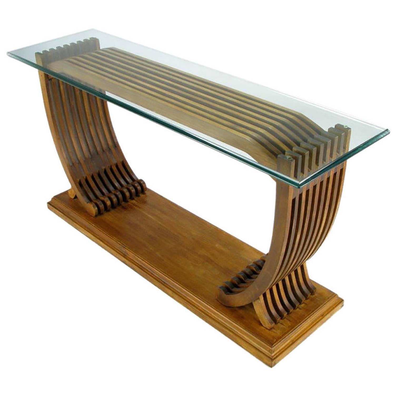 Well constructed teak console table resembling the ribs of a wooden boat, mounted atop a beveled plinth base. Ogee edged 5/8