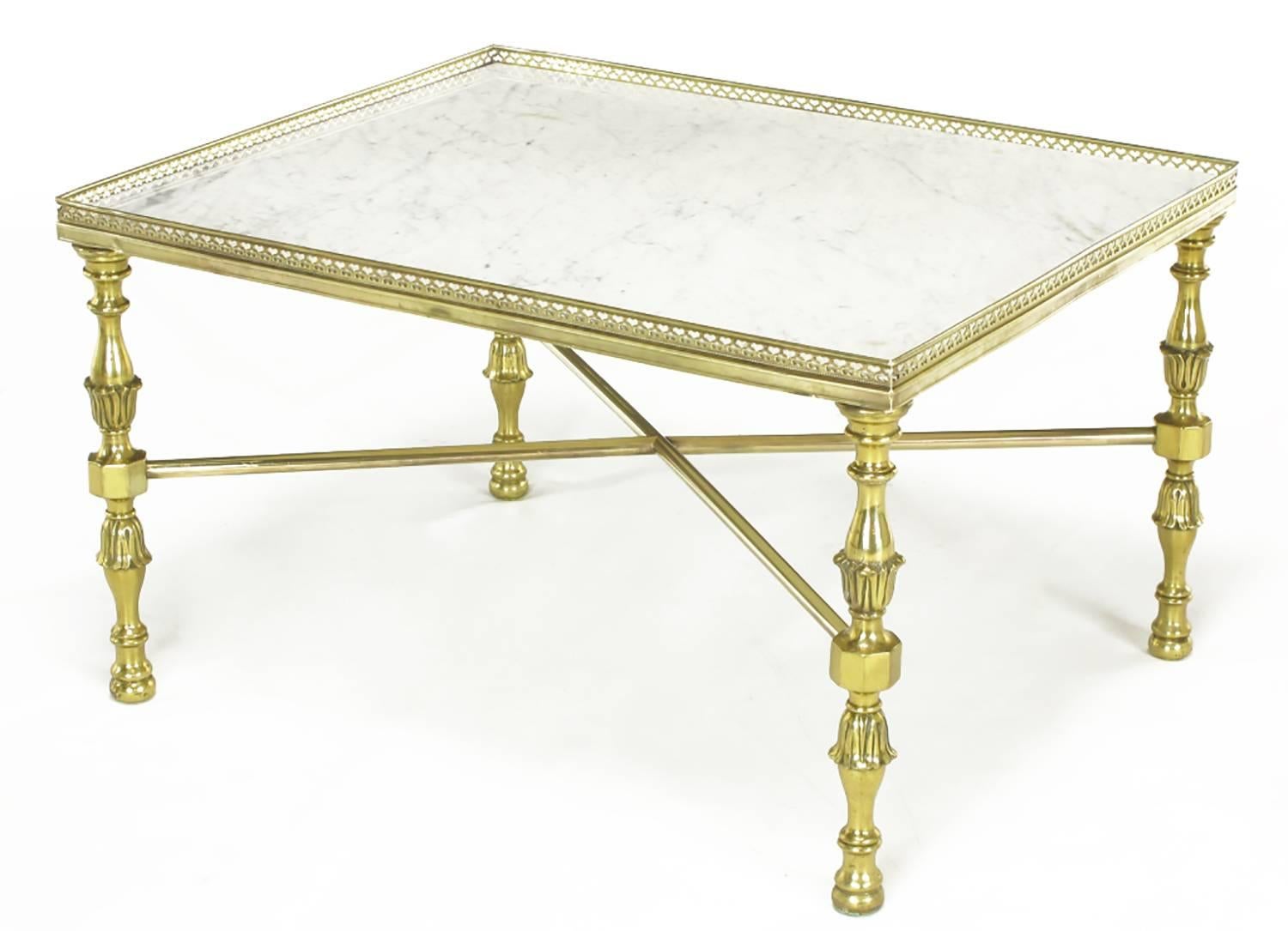 Solid brass and Carrara marble end tables with Regency styled acanthus leaf detailed baluster style legs and X stretcher supports. Pierced gallery top surround. Most probably a custom design of Italian origin that would make a great two-piece coffee