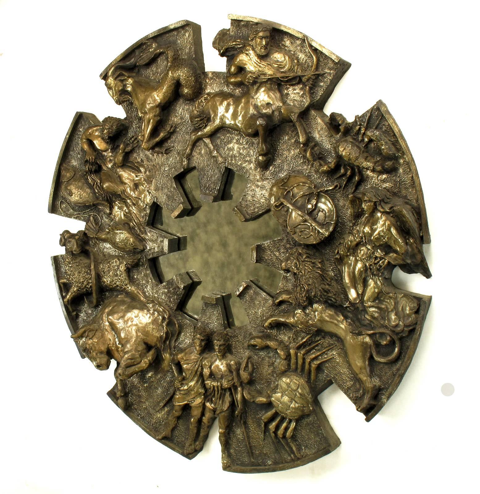 Incredible and finely cast wall mirror with relief symbolic of the 12 signs of the Zodiac. Bronze dipped and patinated with an eight cog gear shaped antiqued mirror. The wall hanging itself is an eight cogged gear like wheel. In ancient mythology