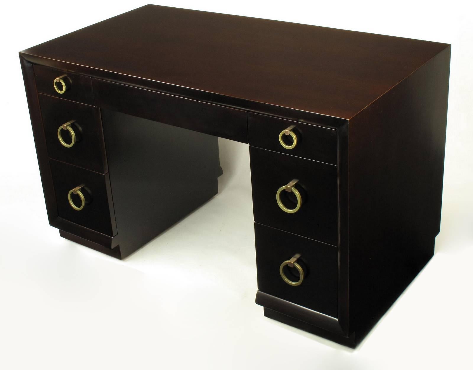 Excellently restored knee hole desk or writing table , model no. 317, by T.H. Robsjohn-Gibbings for Widdicomb. Drop ring pulls are plated in brass and the original patina has been burnished but not polished out gloss brass. The desk back is engraved