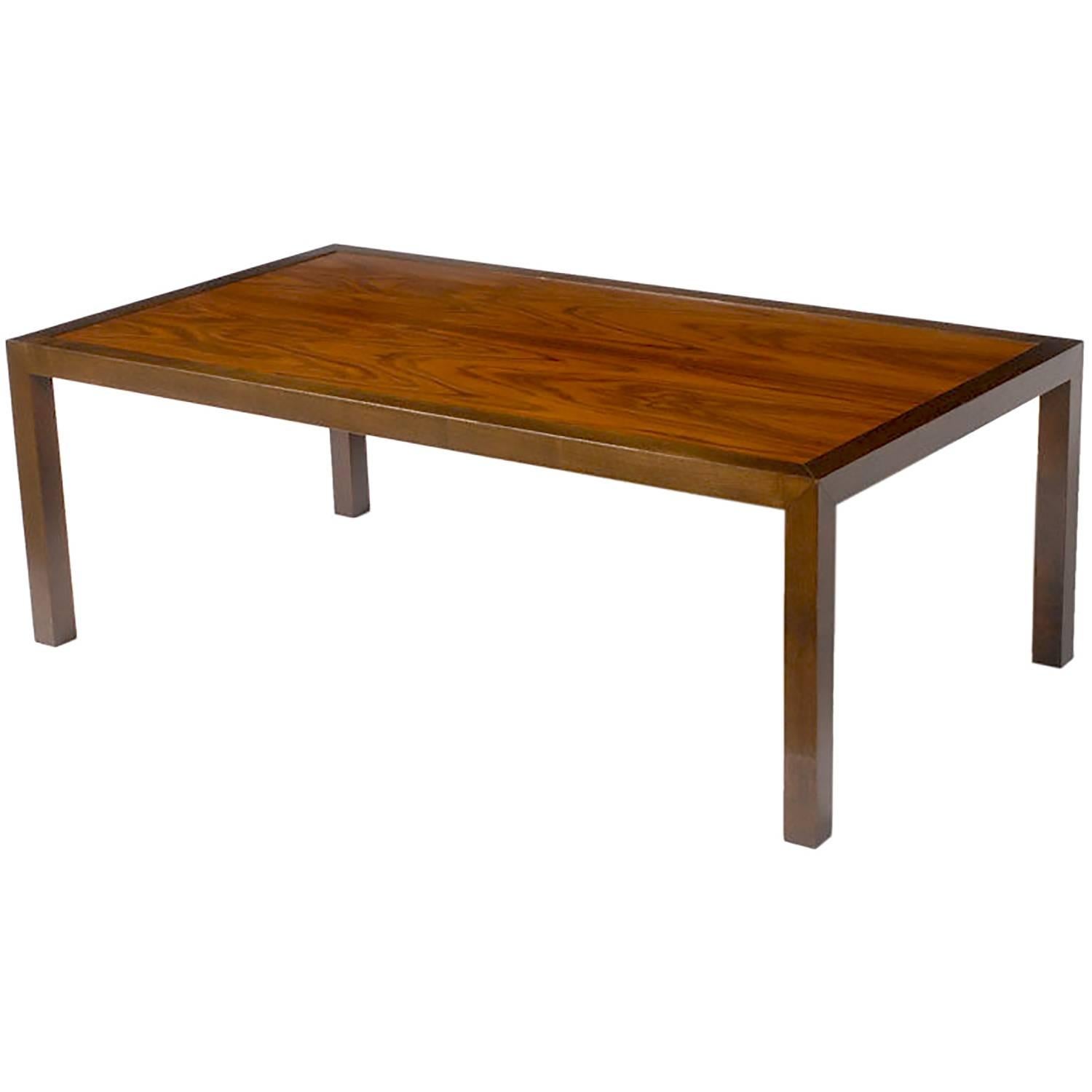 Edward Wormley for Dunbar Parsons style coffee table. Exceptional rosewood grained top with clean lined walnut frame. Transitional piece that could work with many design plans. Gold metal Dunbar label.
