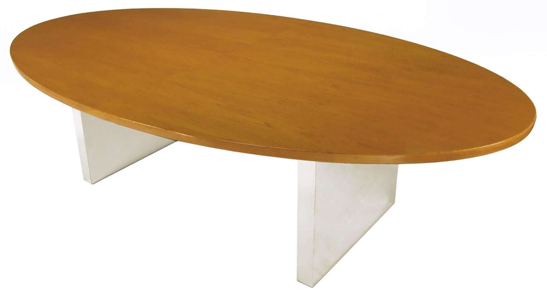Most likely a Roger Sprunger derivation of an Edward Wormley design, Dunbar oval ash wood one piece top dining table. Pair of polished steel over wood panel pedestal legs. Would also make a wonderful executive desk. 52
