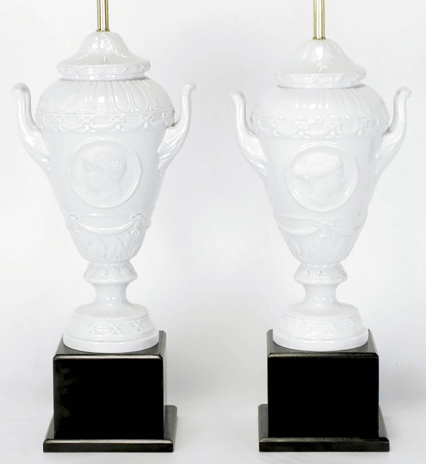 German Pair of White Porcelain Urn Table Lamps with Male and Female Busts in Relief For Sale
