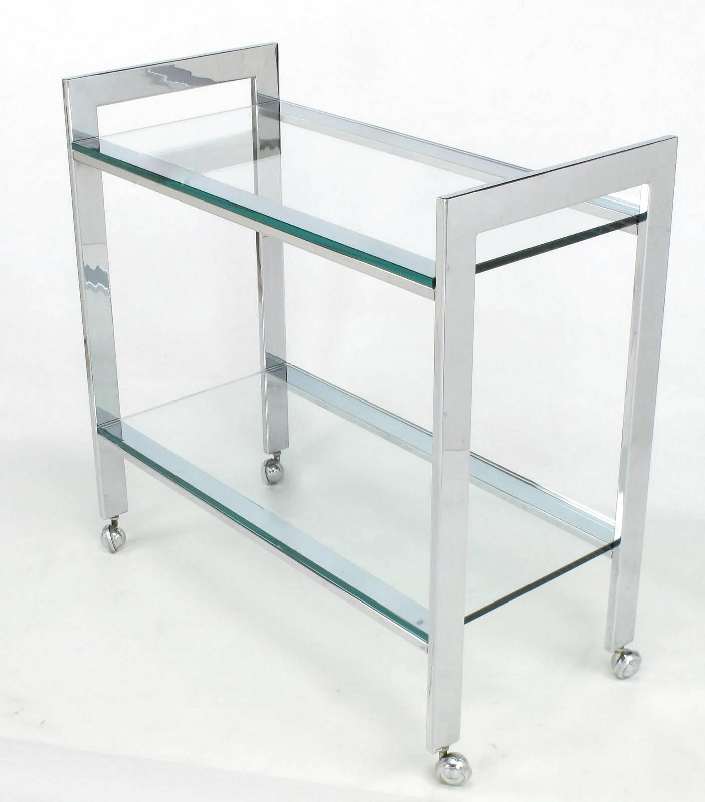 Chrome and glass bar cart of serving trolley in the style of Milo Baughman for Thayer Coggin. Two glass tiers with chromed steel frame and chrome casters.