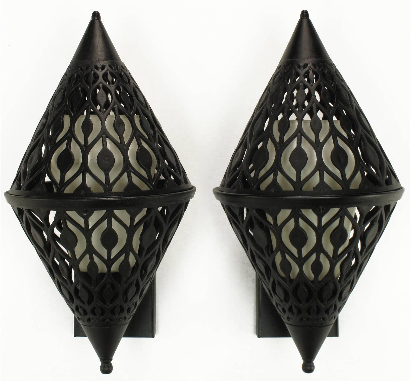 Restored pair of Gothic inspired black enameled and pierced aluminum sconces. Diamond shaped with rectangular back plate. Most probably of French origin, internal milk glass shades with threaded porcelain sockets and fitter rings. Can be hung as