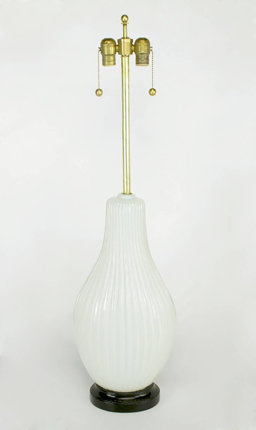 Ribbed and opaline Murano glass table lamp with black lacquered metal base. Elongated gourd form body with vertical ribbing. Brass stem and double socket cluster. Sold sans shade.