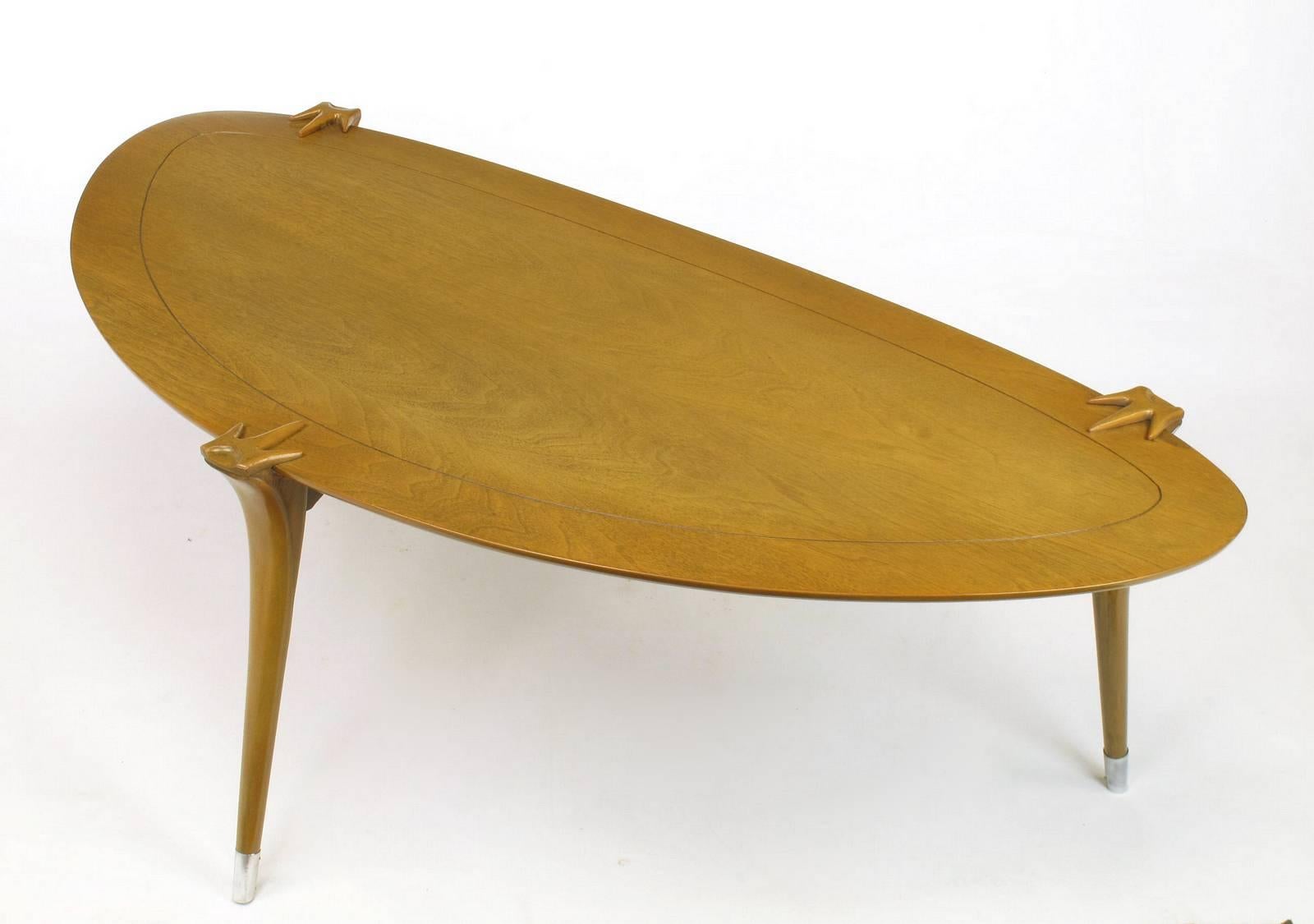 Bleached walnut triangular shaped coffee table, circa 1950s. Talon style cuffed legs with polished aluminum sabots and incised border top. Uncommon in shape and detail.