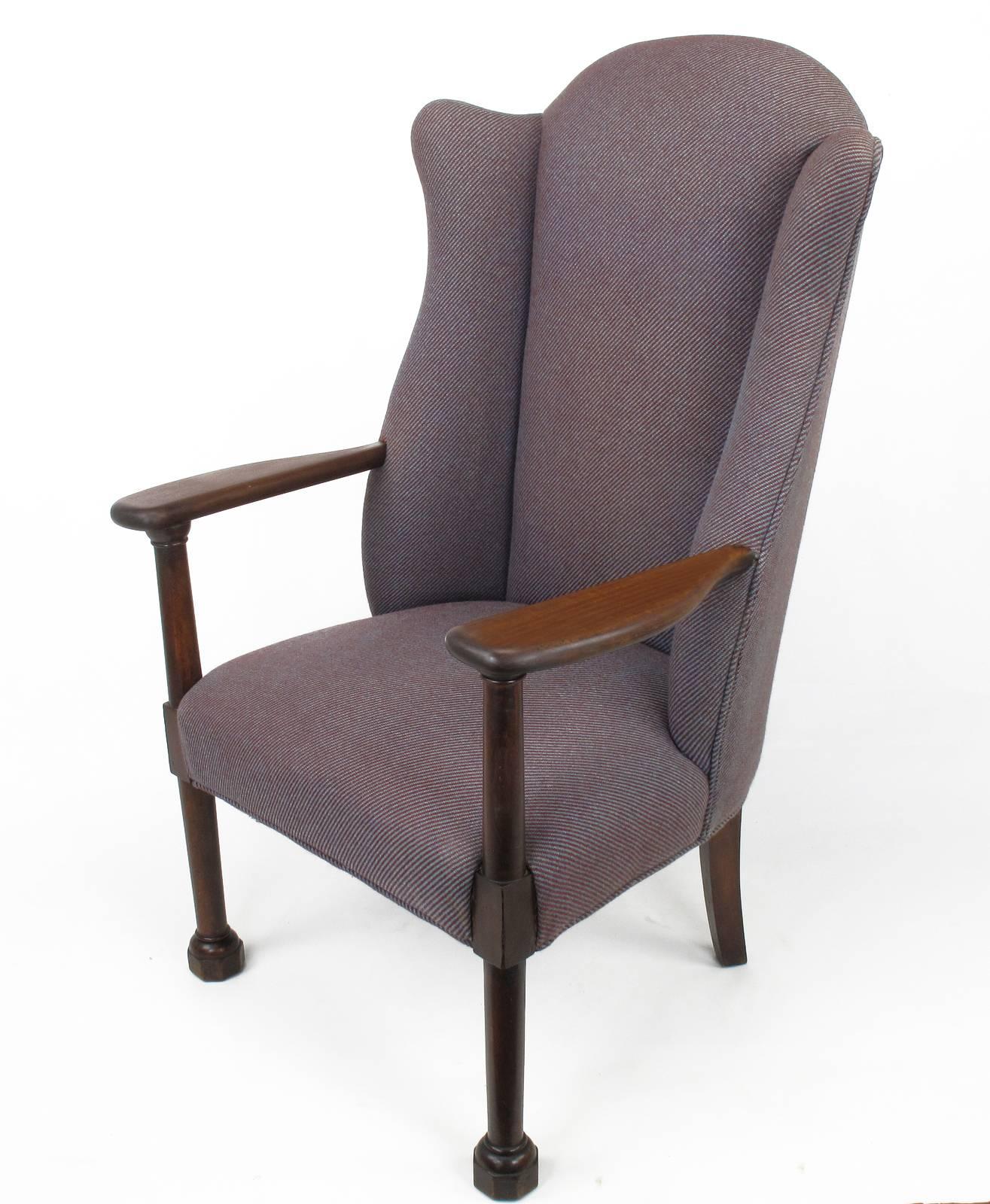 Late 1800s English arts and crafts wingback chair. Mahogany frame with slab open arms, octagonal plinth feet and large dowel style arms and legs. Older striped periwinkle and magenta wool upholstery in good condition.