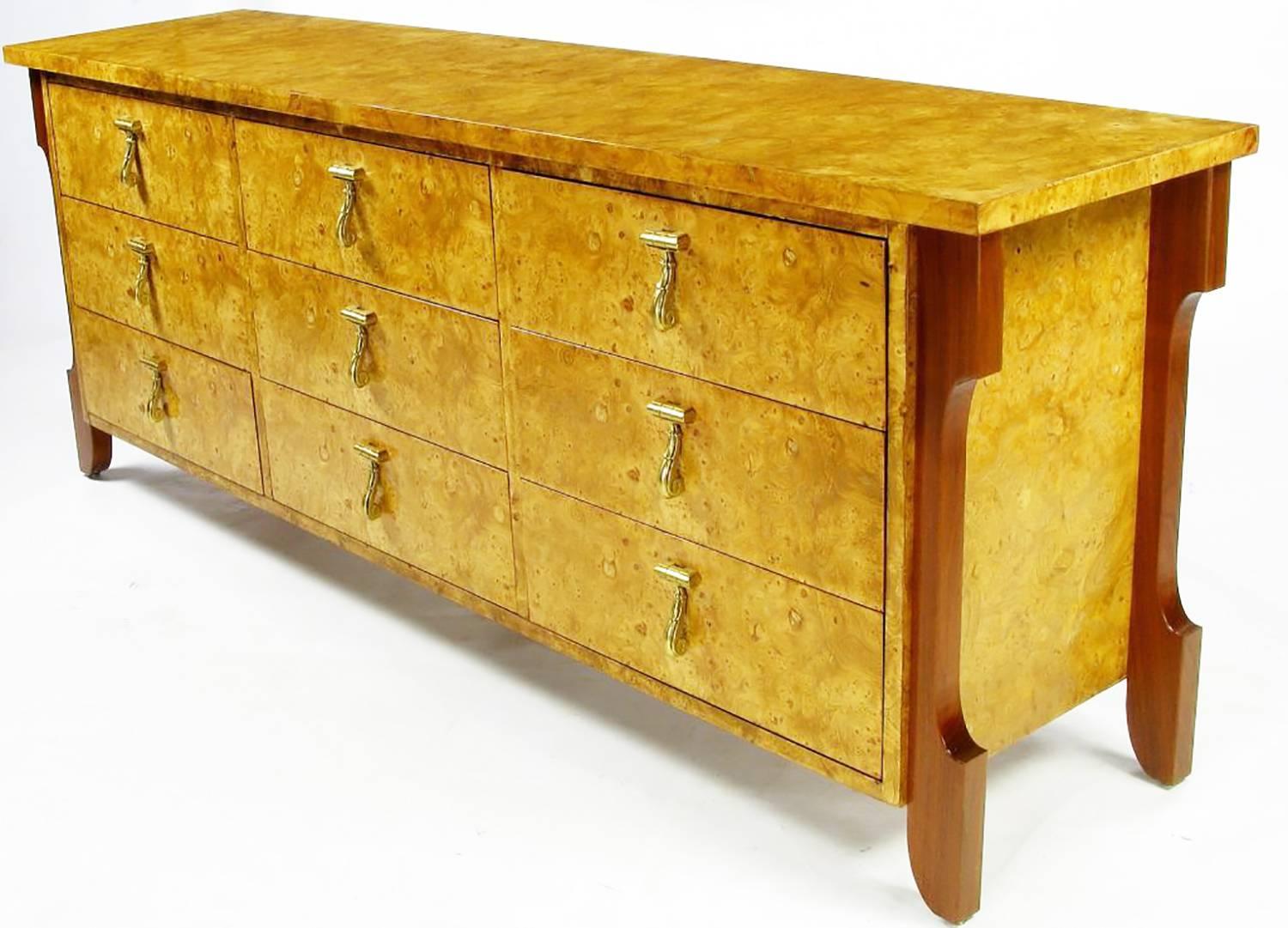 Olive ash burl and custom created legs make for a unique and elegant Mastercraft nine-drawer dresser, or chest. Legs are solid and quite thick walnut. Heavy drop pulls of solid cast brass. Would also make an impressive credenza or sideboard.