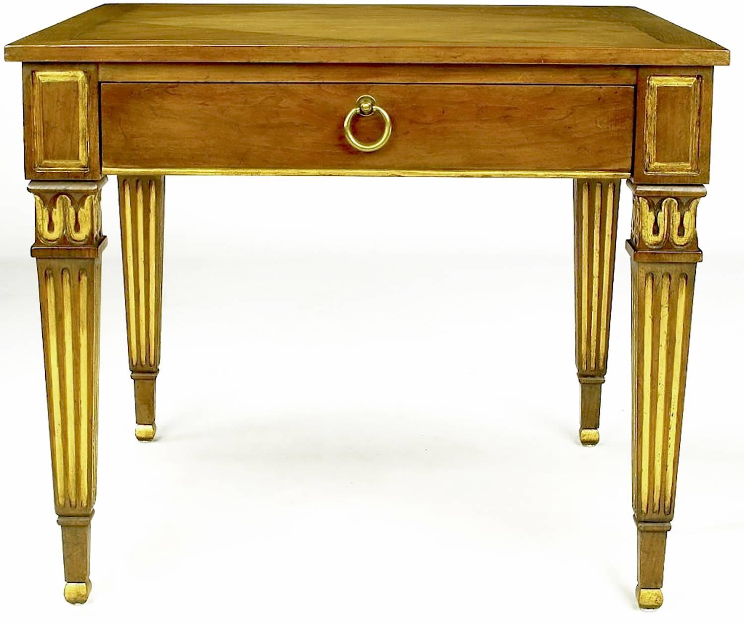 These outstanding walnut side tables from Baker feature diamond pattern parquetry inlaid tops and parcel-gilt fluted Louis XVI style legs. A single drawer is accessed by a brass drop ring pull. An exquisitely designed pair.