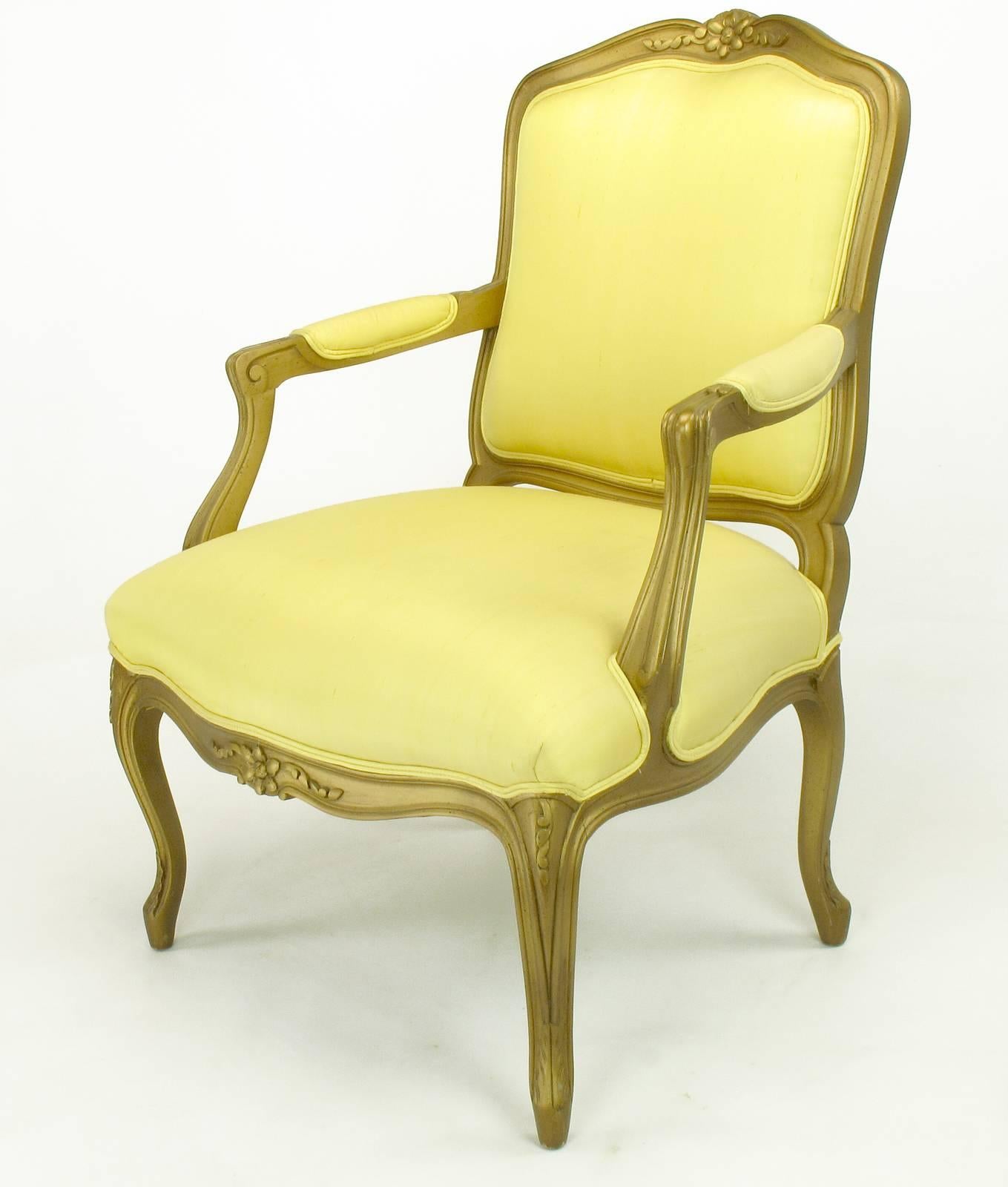 1940s giltwood Louis XV style armchair with saffron silk upholstery. Carved wood frame has been restored and gilt with black glaze. Arm height is 24.5
