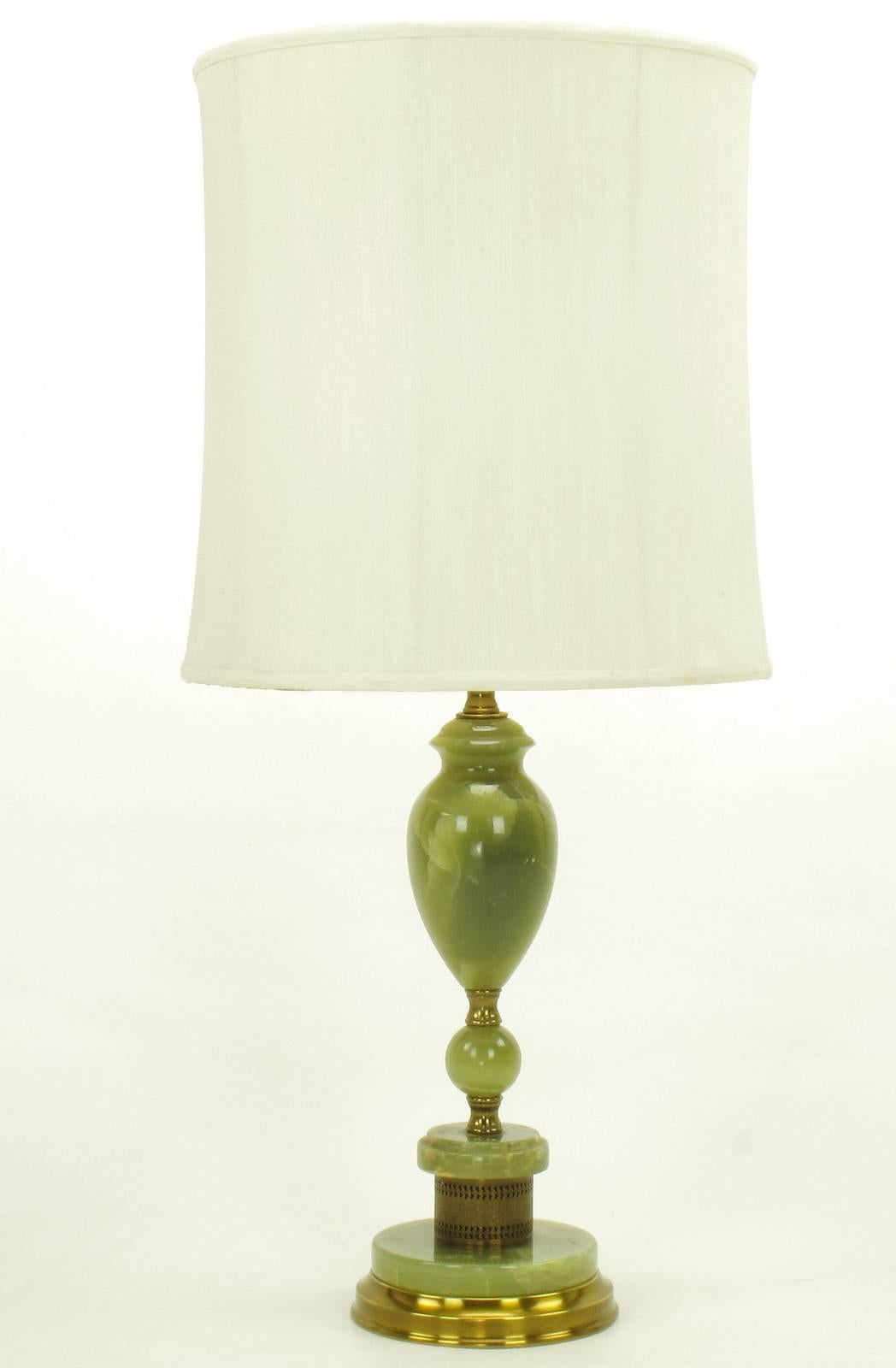 Pair of 1940s green onyx table lamps with solid and pierced brass spacers. Segmented solid onyx spheres and discs with urn shaped body. Rewired and restored with new double socket clusters and ball and chain pulls switches. Sold sans shades.