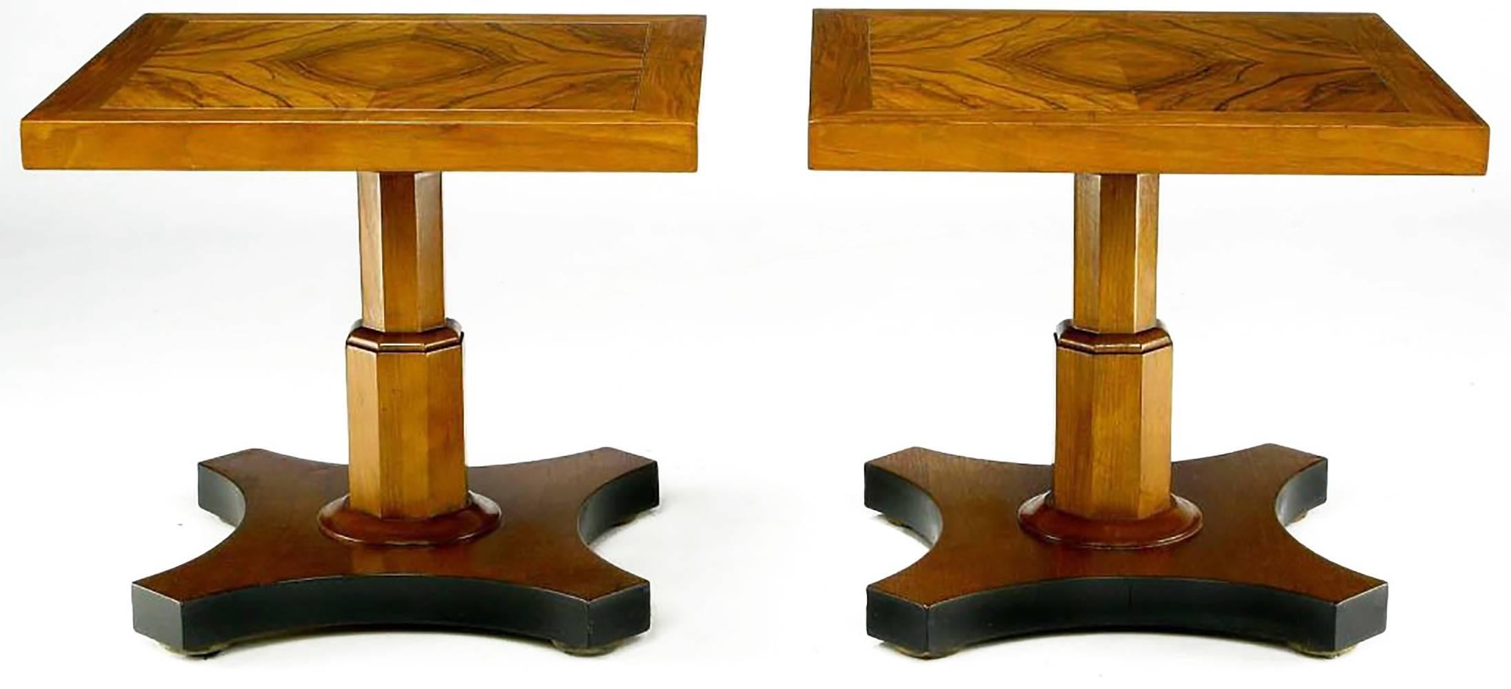 Beautifully figured walnut tops and walnut pedestals with inverted quatrefoil walnut base creates a stunning pair of side table from Baker Furniture. The base sides are accented by a satin black lacquer finish. Would make a striking two part coffee