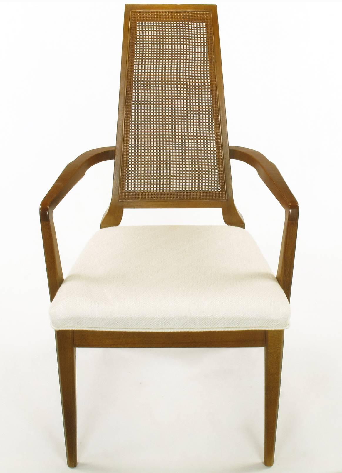 1950s Modern set of six Danish weave cane back dining chairs. Finely carved walnut frames with uncommon details such as the curved narrow backs and sculptural legs. Upholstered in a woven Haitian cotton with relief detailing.

Armchairs measure: