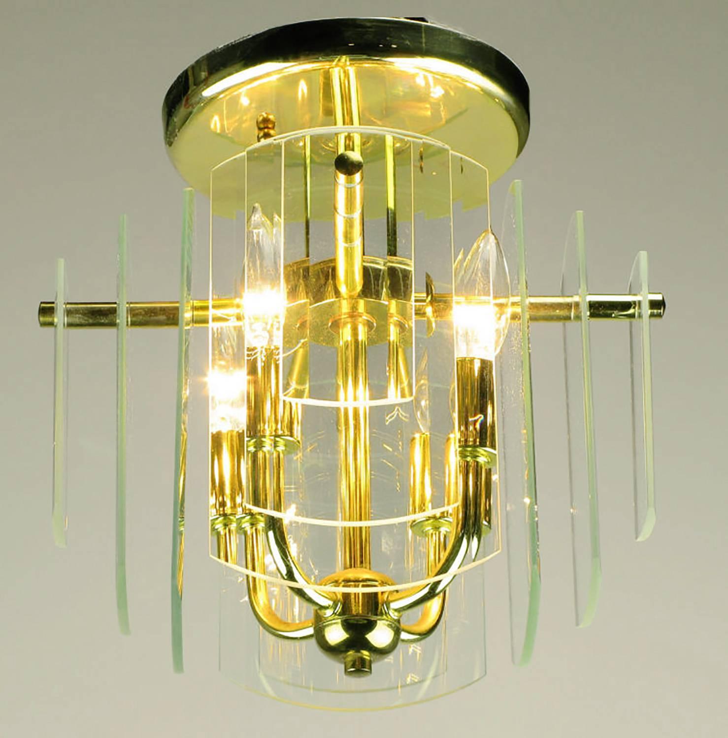 A pair of brass four-arm ceiling lights with four sides of graduated and beveled glass. Each side features three layers of glass plates that step down in size from the center. One of three pairs available.