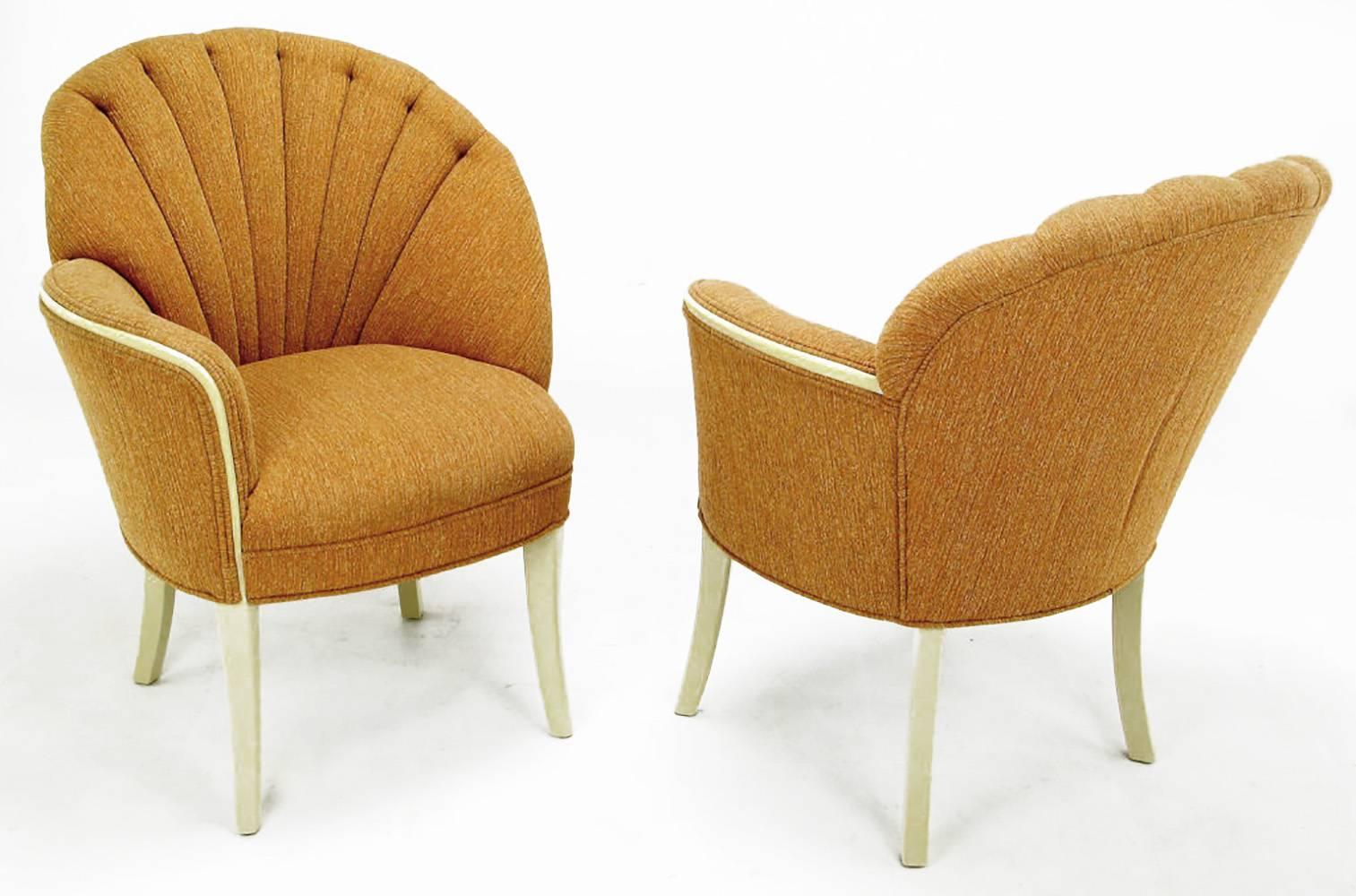 Elegant pair of mirror image Art Deco shell back fireside chairs in heathered cinnamon-orange upholstery. Solid mahogany frames and legs have been refreshed with new taupe lacquer. Second pair in different upholstery and mahogany wood frame