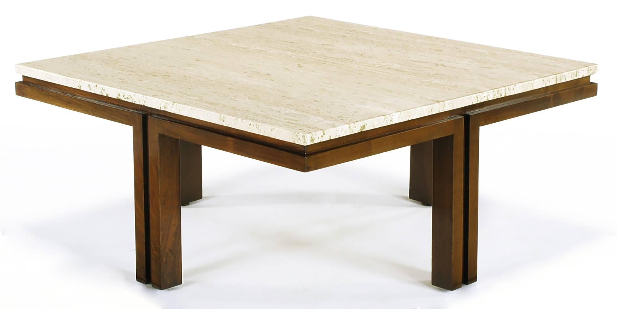 Walnut wood and travertine top coffee table with legs centered on the sides. Each leg comprised of the union of a pair of wood verticals with open center and top reveal, then placed in the center of each side of the square. Uncommon design that from